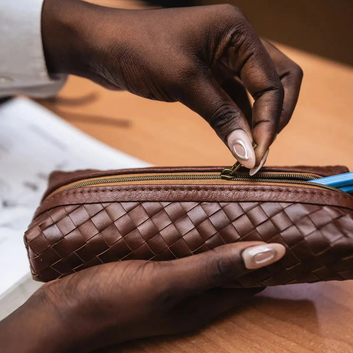 Brown woven pencil case, top view on white background