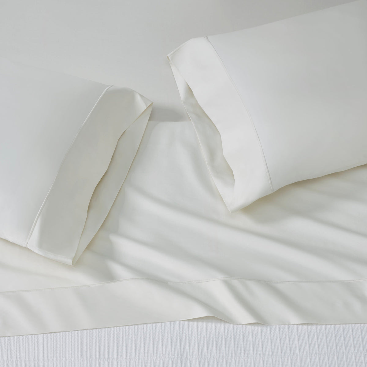 KFL-545-7880_4|Top-down view of inviting cream 100% cotton sheets with two plush pillows, ensuring soft, breathable comfort for a tranquil night's sleep.