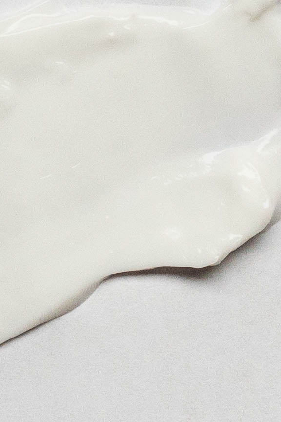 Close-up of Merigold Mindful Citrus Hand Cream texture – rich, white, creamy formula designed to hydrate, soften, and nourish dry hands.