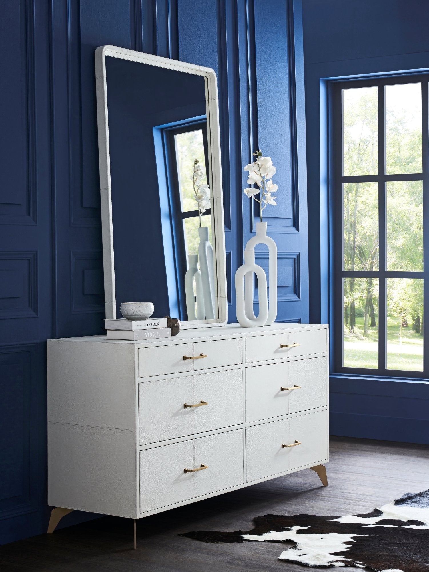 FN-5201-642033_1|Stylish white genuine leather dresser with gold handles and legs, offering elegant storage in a modern bedroom furniture setup.