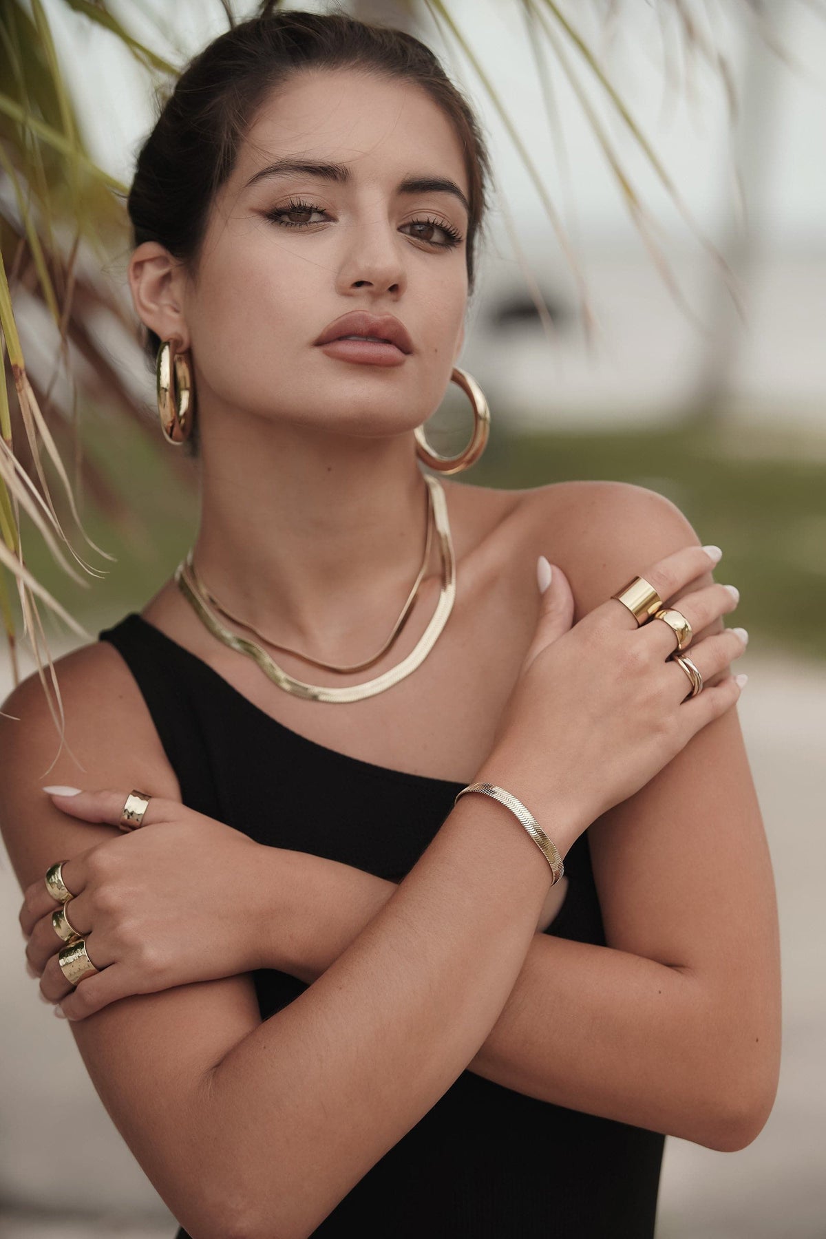 Woman rocking a stylish 5mm Viper Chain Bracelet with shiny gold jewelry