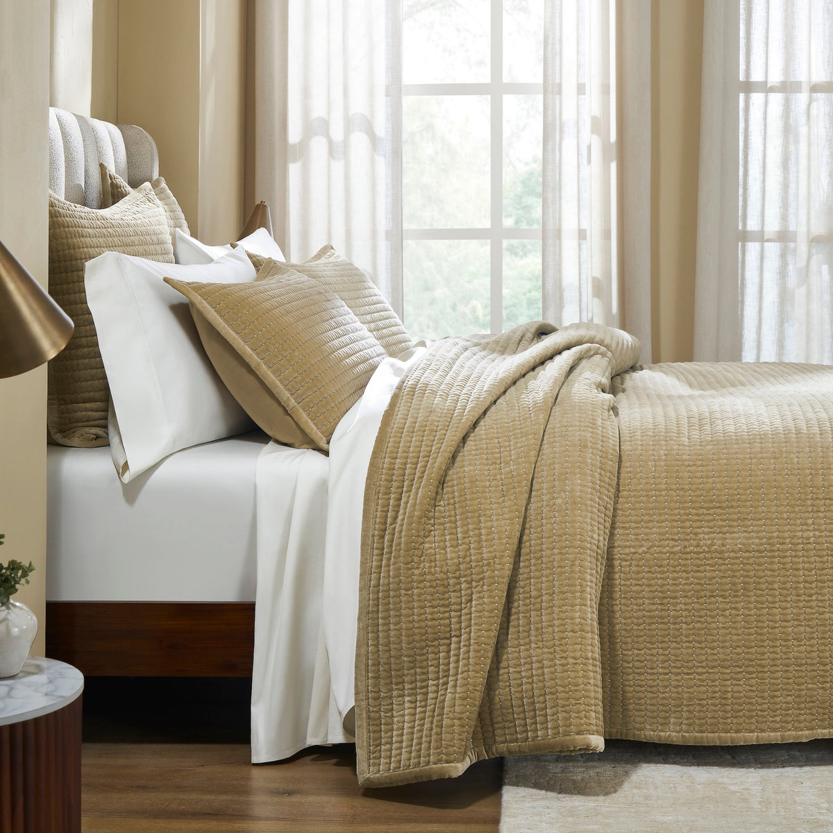 CL-267-9496_3|Elegant gold quilted velvet coverlet and matching shams enhancing a modern bedroom design, offering sophisticated comfort and style.