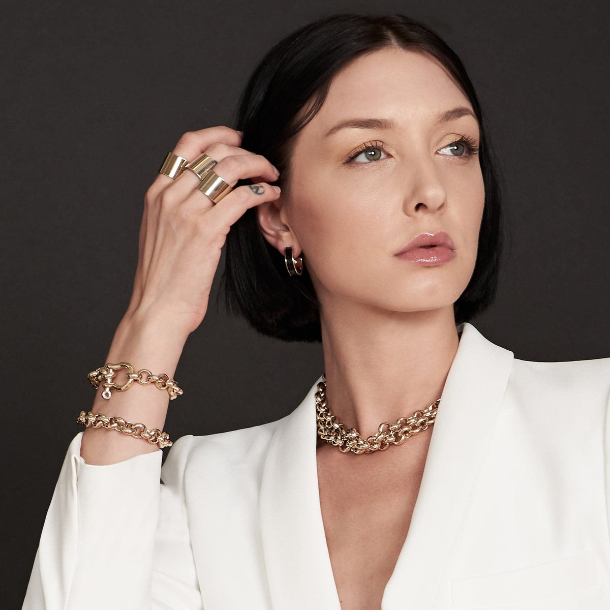 Woman wearing stunning gold jewelry showcasing the Royal Bracelet style