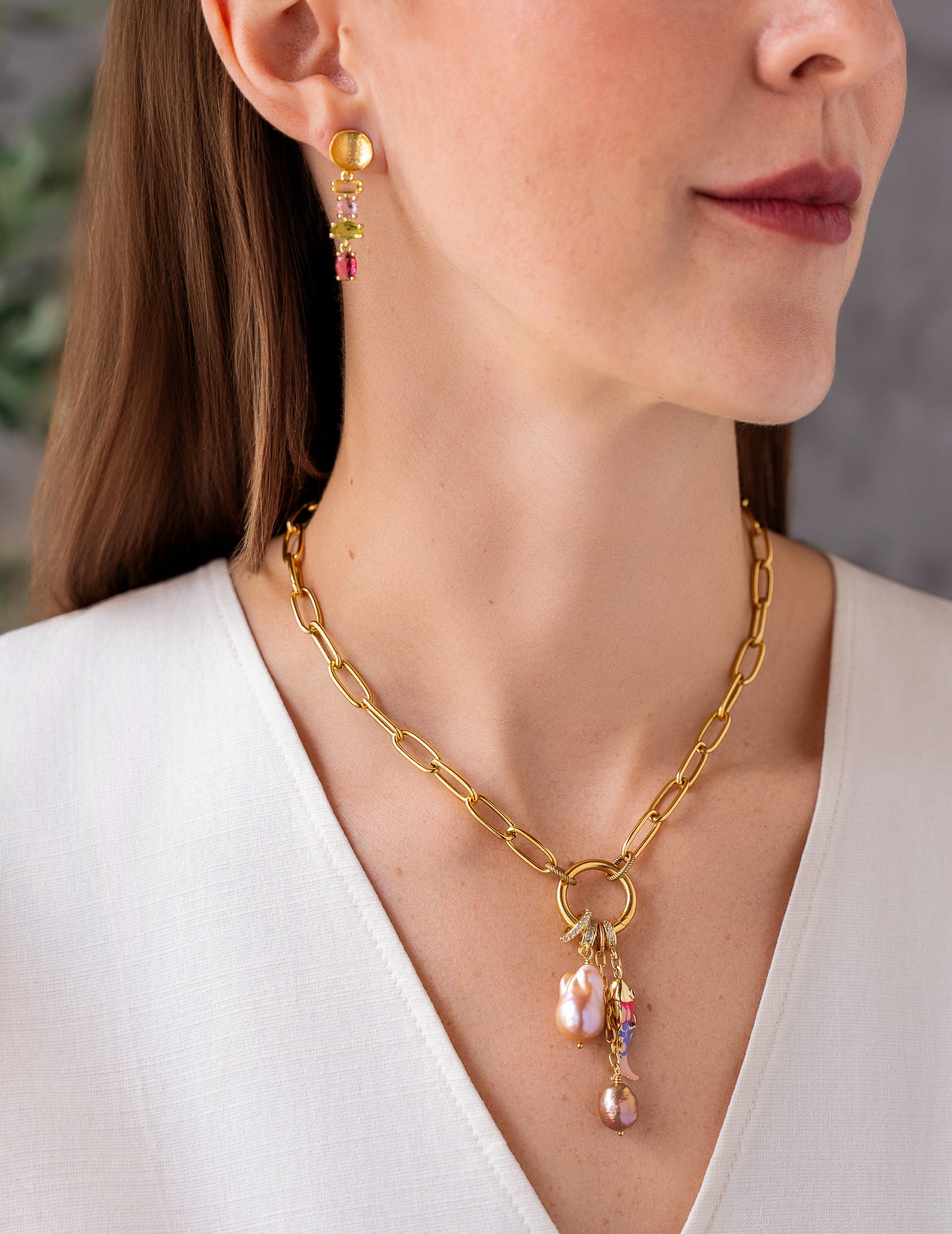 Gold chain necklace with freshwater pearl and colorful charm cluster pendant.