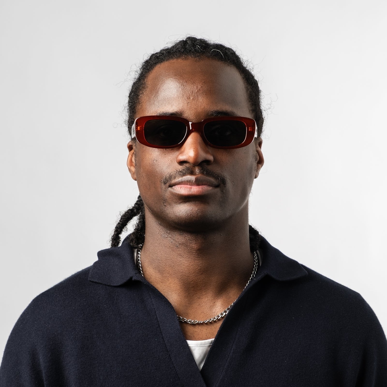 Male wearing Sad Eyewear Bouquet rectangle sunglasses in blood red with black tinted lenses