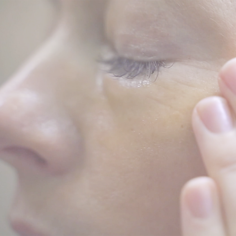 Video Close-up of woman gently applying Annmarie Wild Fruit Serum to the eye area for brighter, smoother-looking skin