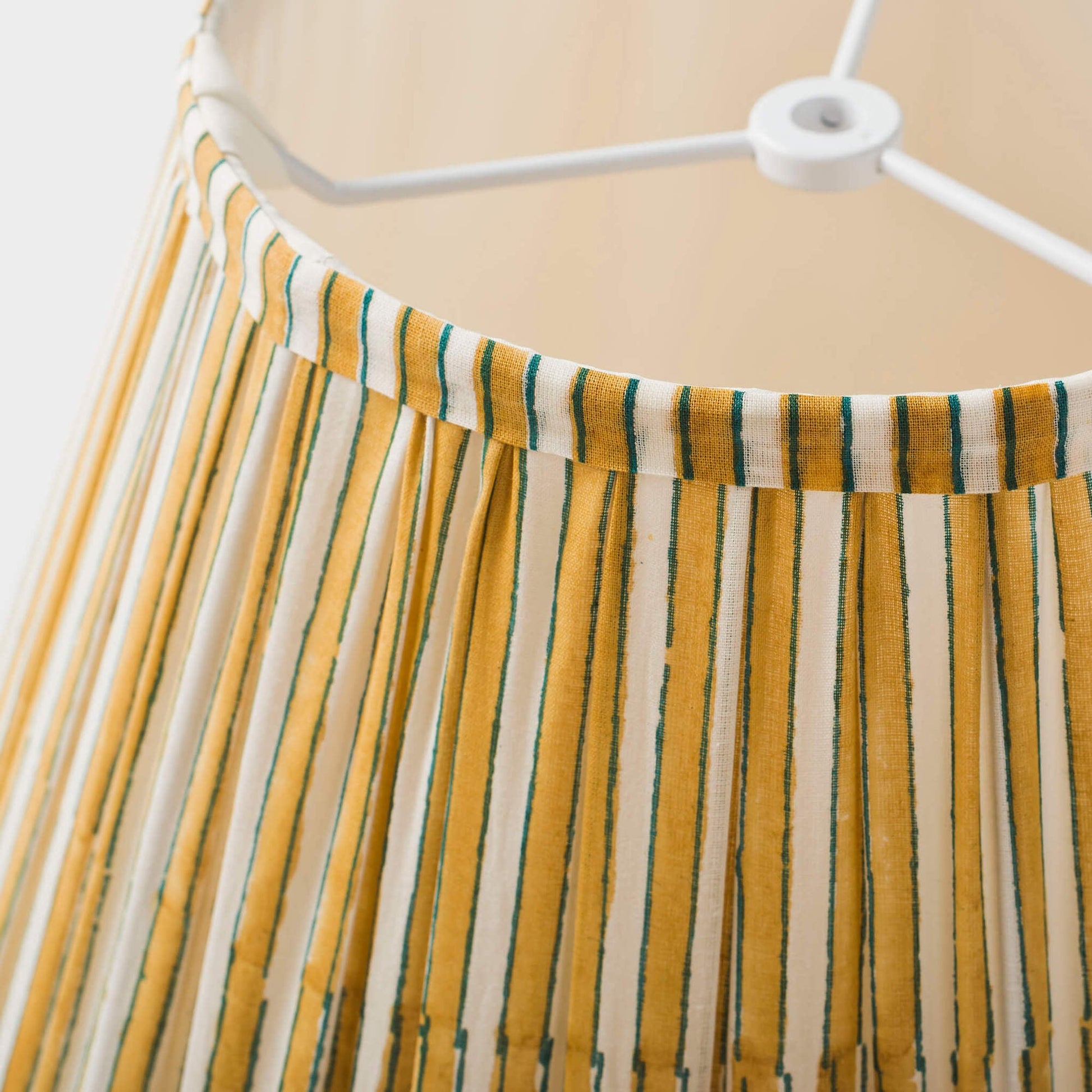 Macro shot of the soft cotton fabric and uniform pleat detail of the Candystripe shade.