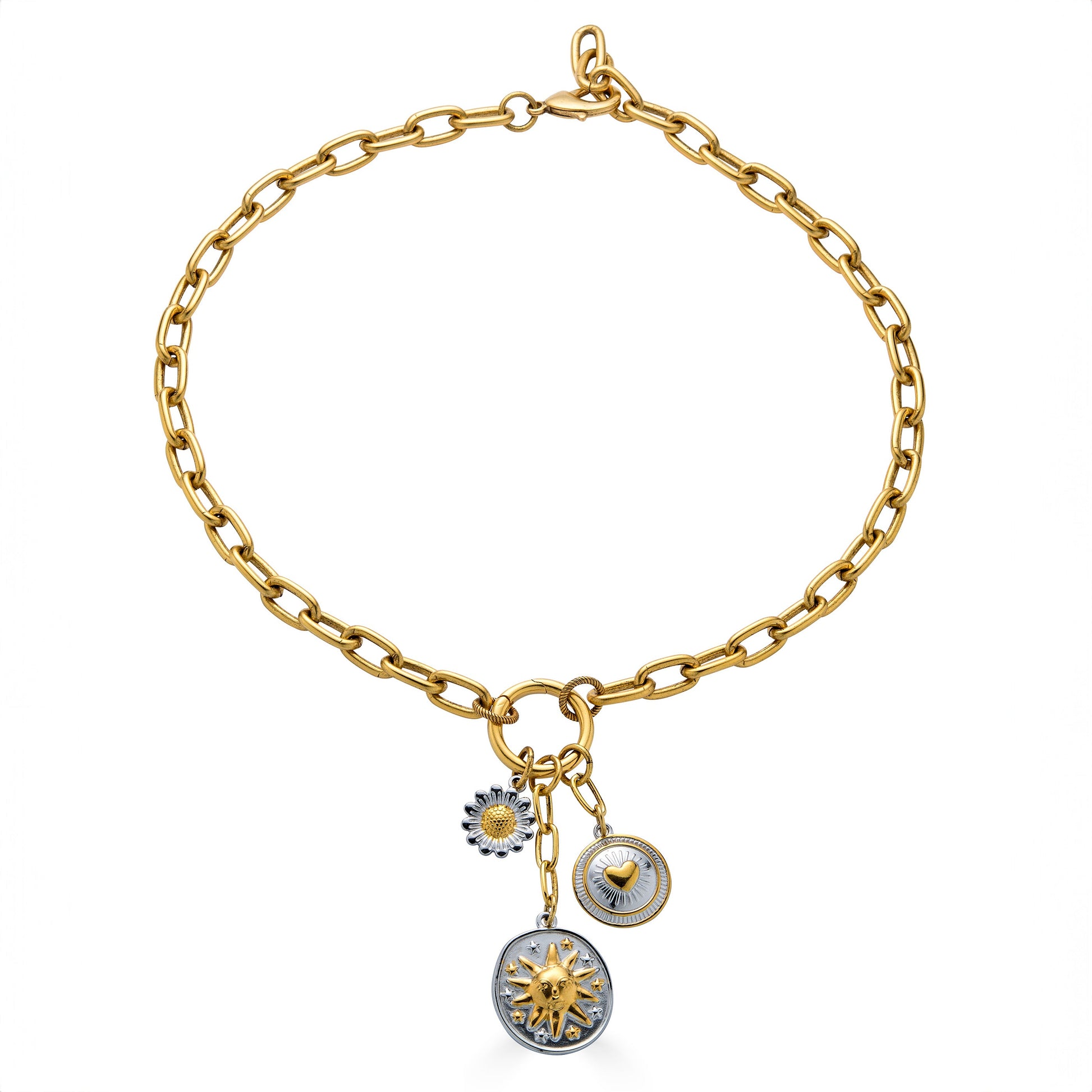 Mixed metal charm cluster necklace with sun medallion, heart charm, and daisy charm on a gold paperclip chain.