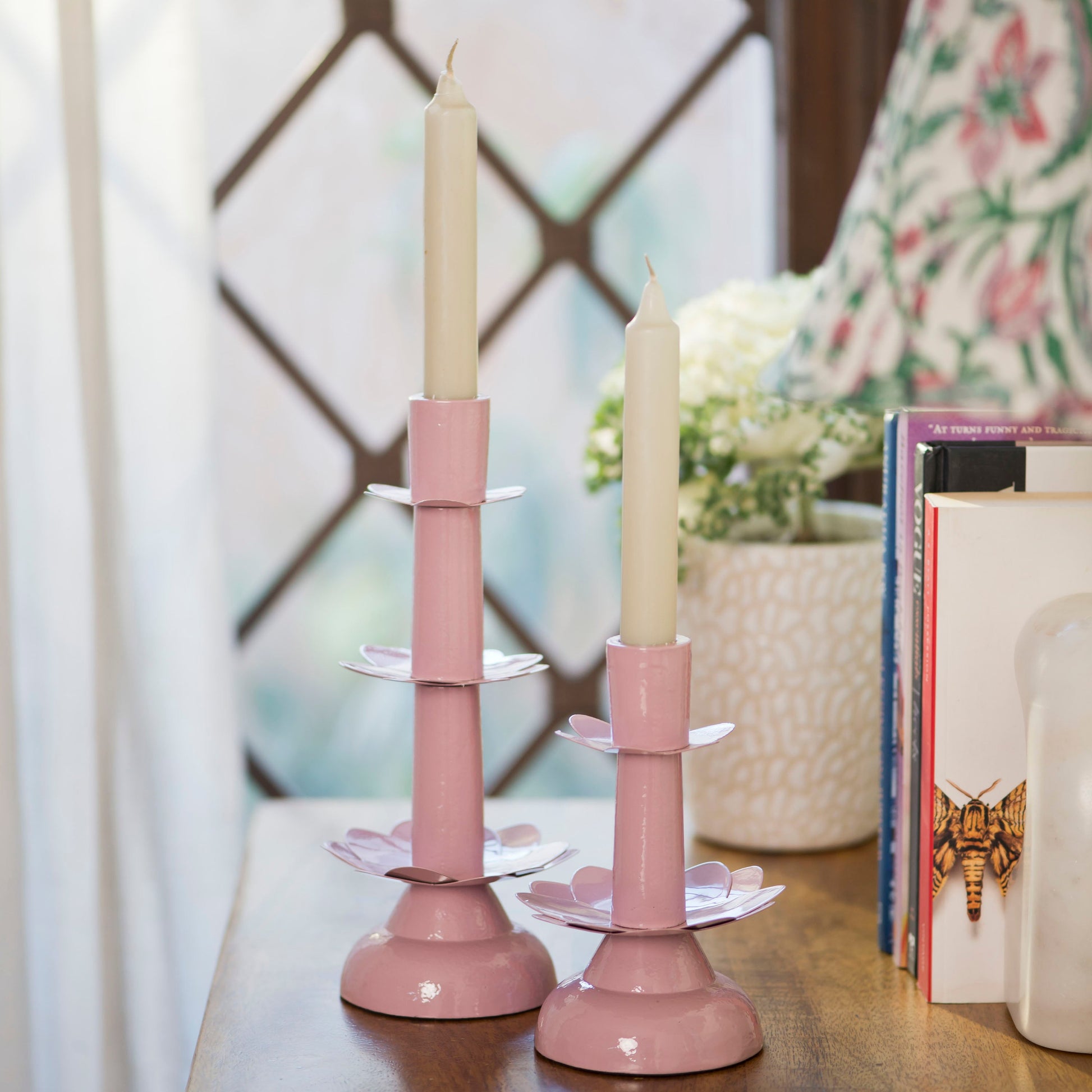 Pastel pink lotus-inspired taper holder featuring elegant curved metal petals and a slender modern silhouette.