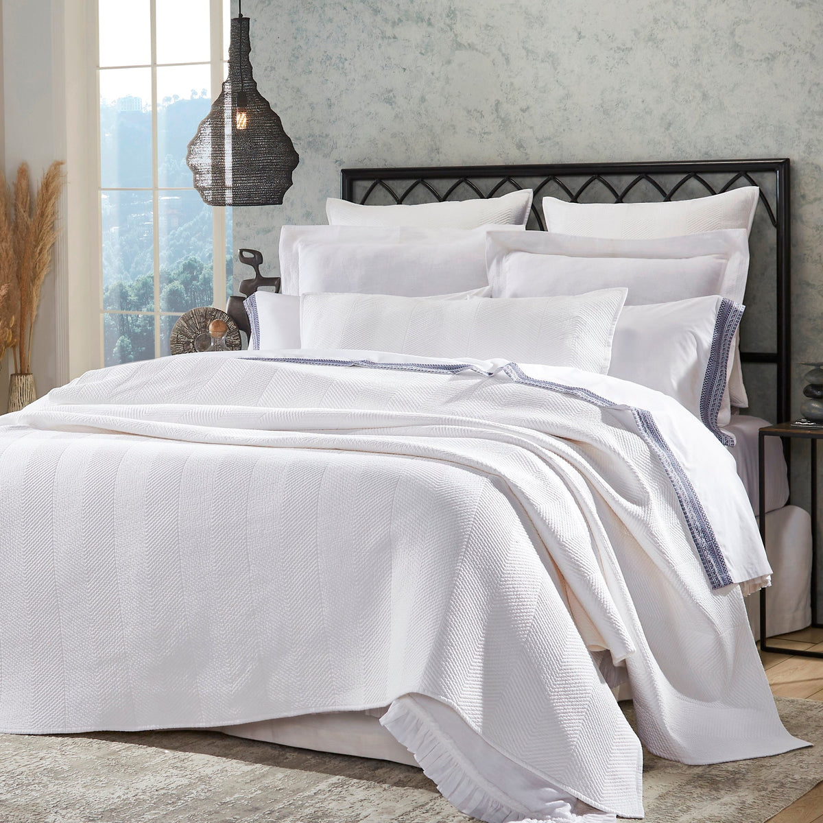 CL-170-9496_3|Close-up of elegant white chevron woven coverlet on a plush bed, showcasing its textured pattern and sophisticated design.