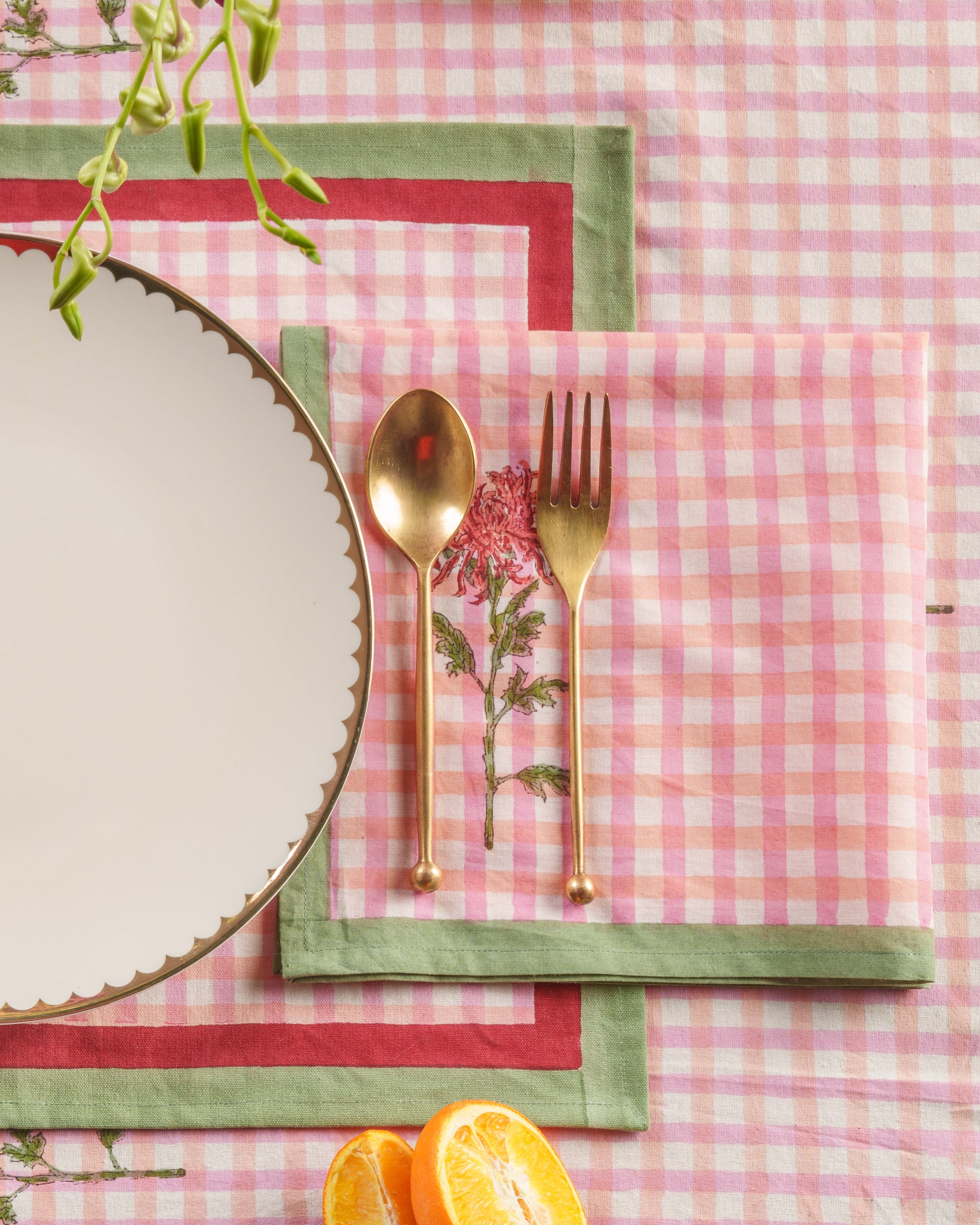 Napkins with gold utensils featuring dahlia blockprint design