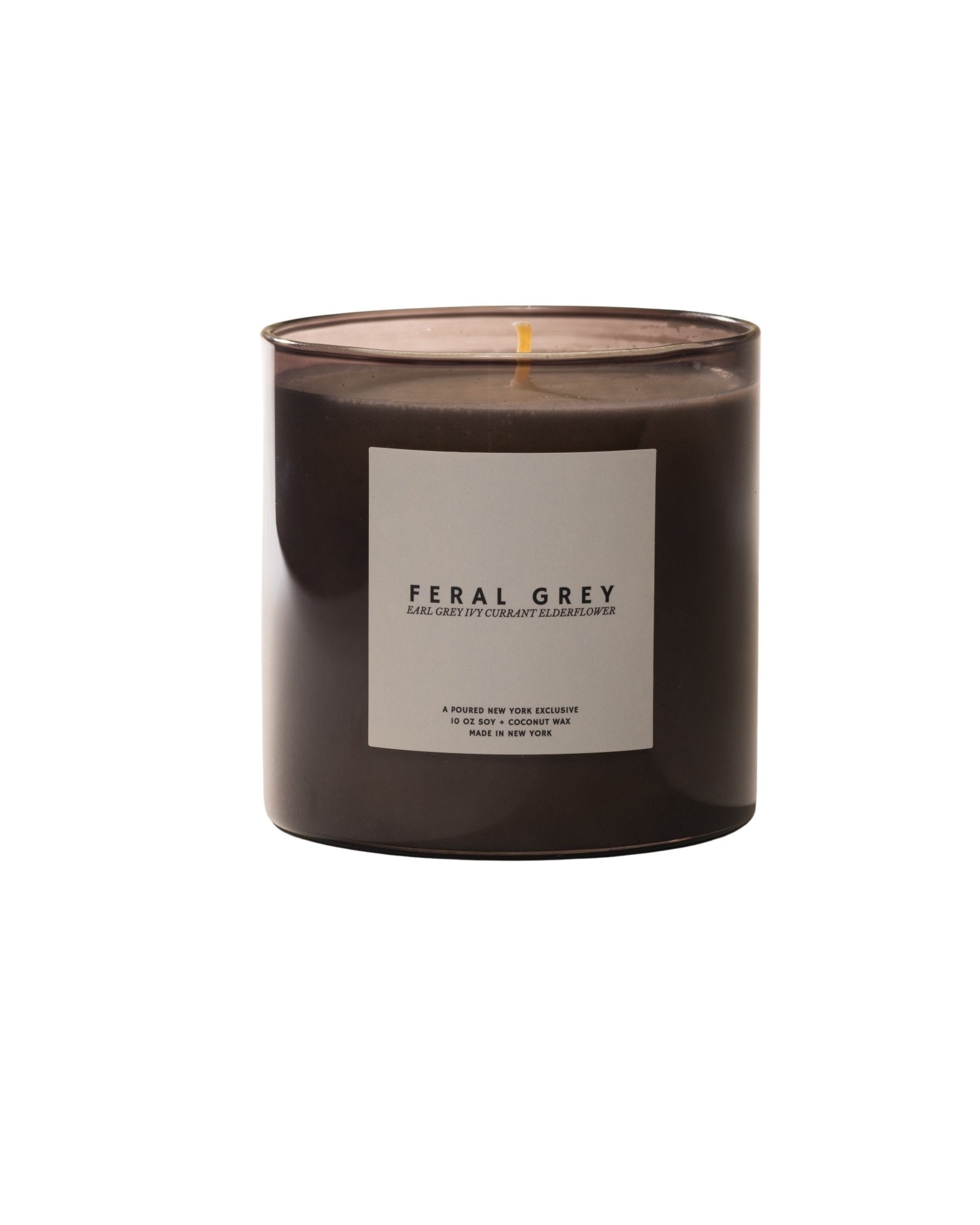 Poured New York 'Feral Grey' candle in grey glass and a matching grey box with an ivy and currant decal on a neutral background.
