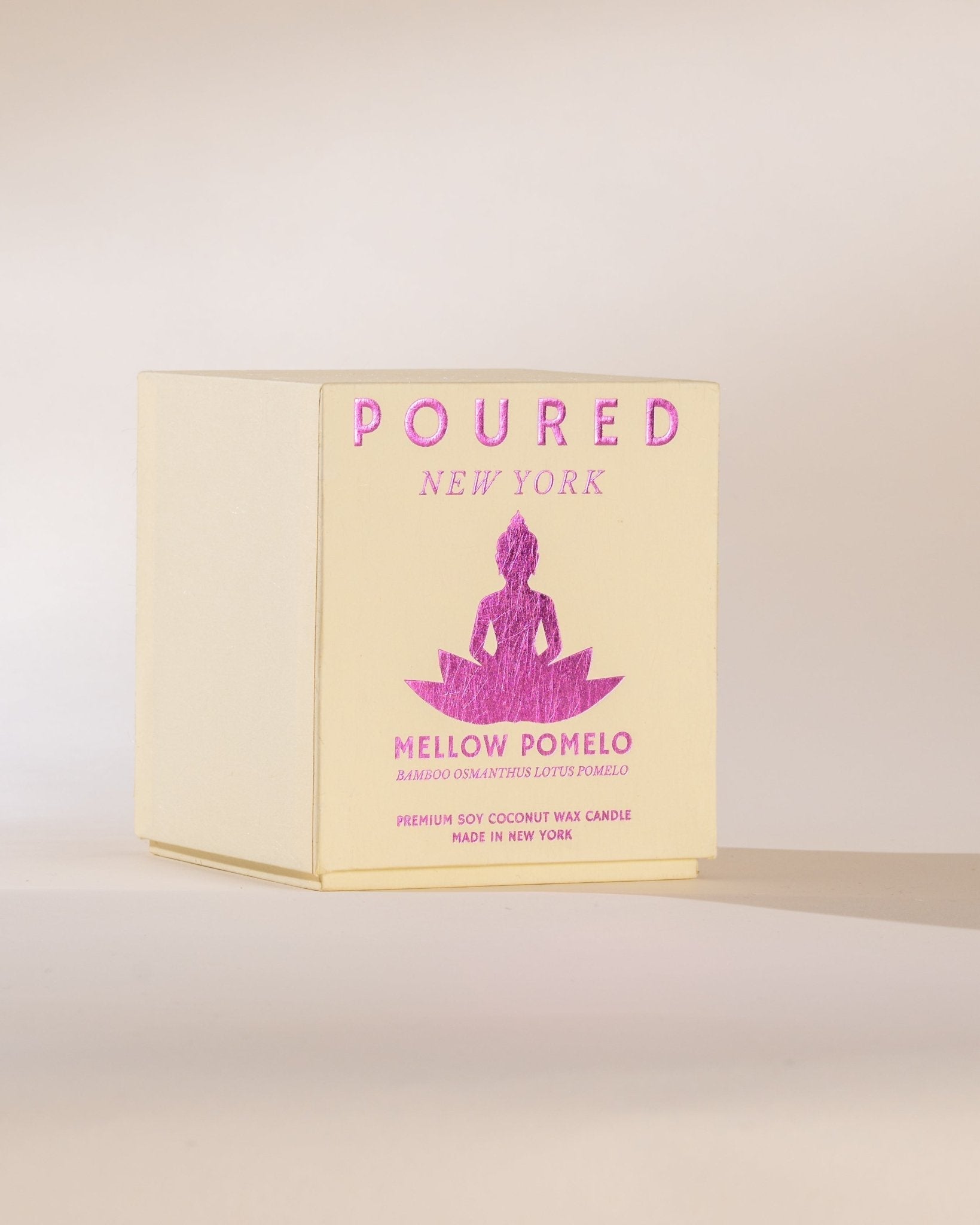 Poured New York 'Mellow Pomelo' candle box on a light background