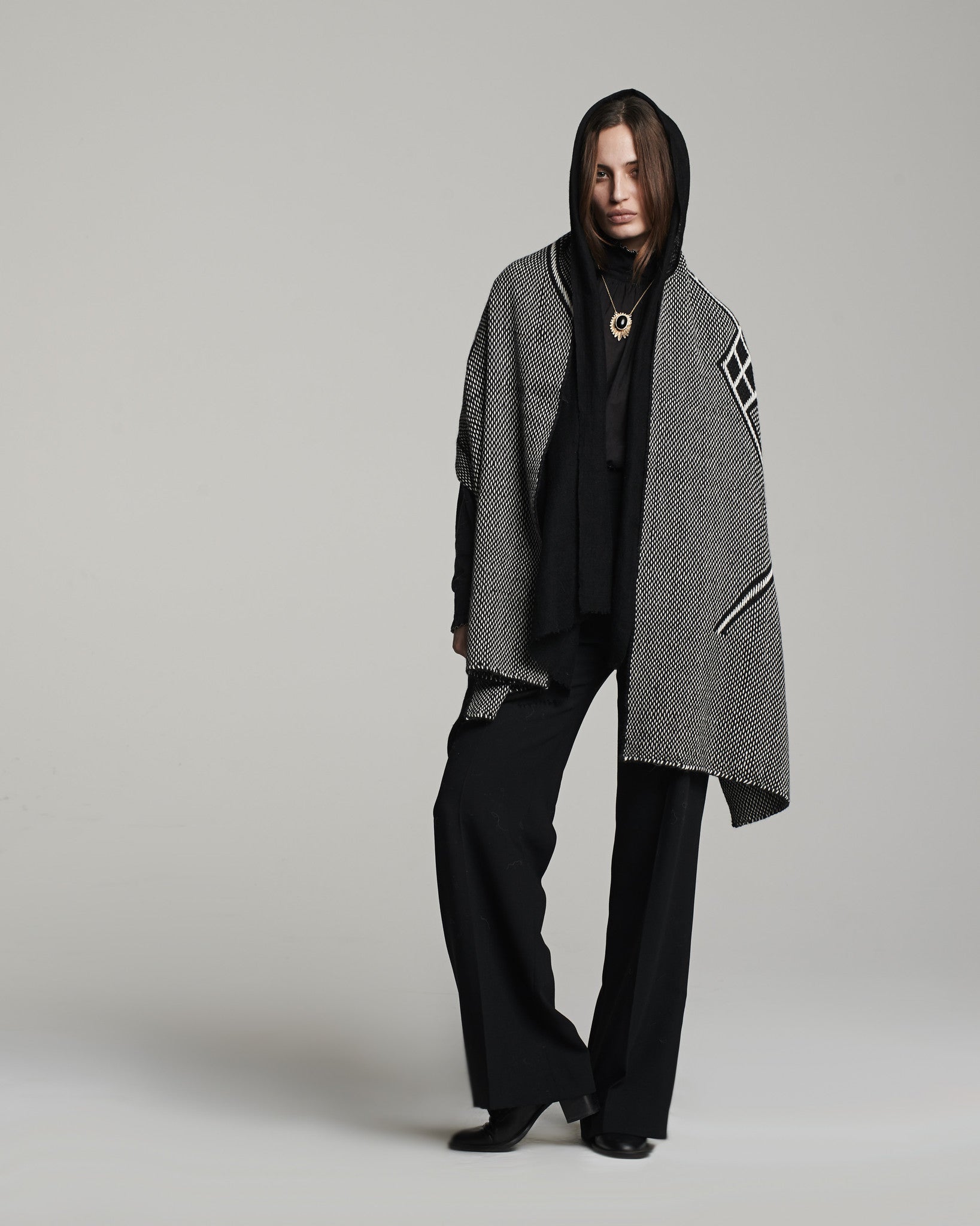 Model wearing a black and ivory Che Shawl, showcasing its design and style.