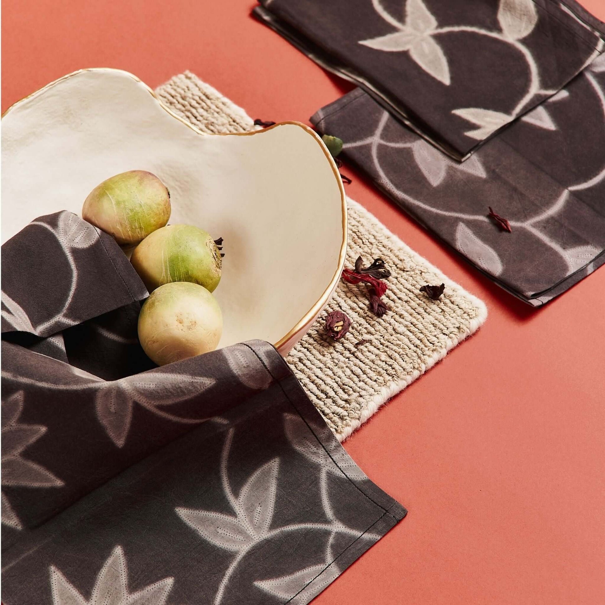 Folio Black Handcrafted Shibori Print Cotton Table Napkins ( set of 4 ) elegantly displayed with a decorative bowl.