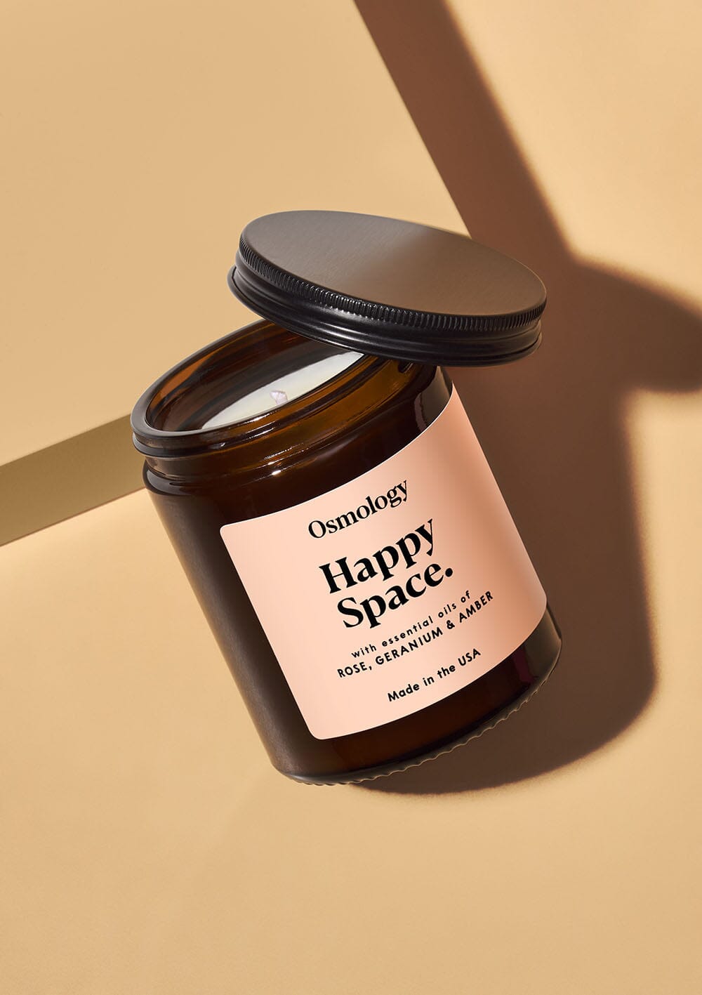 Osmology Happy Space jar candle with open lid on white background