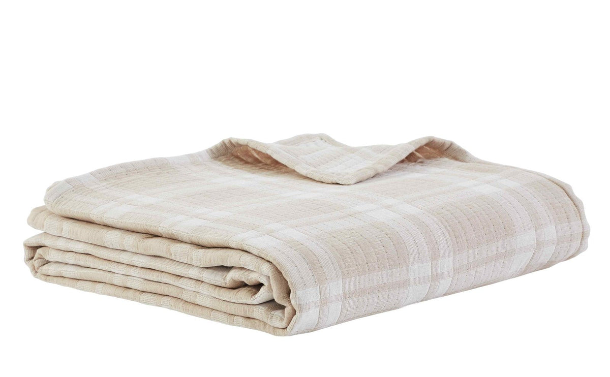 BT-118-9496_3|Neatly folded soft beige and white plaid textured cotton blanket, ready for storage or cozy use on a cool evening.