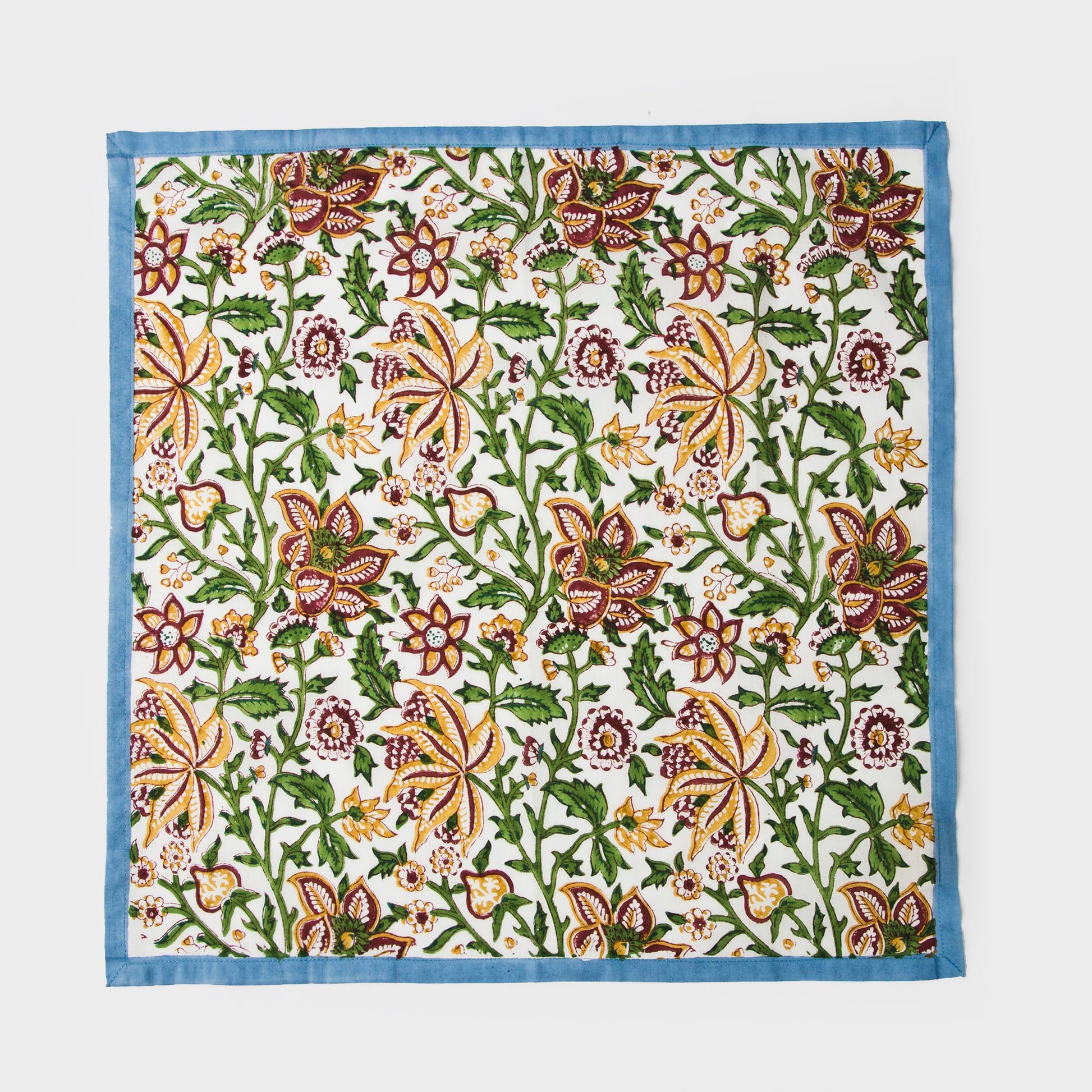 Full view of one Florin napkin showing central floral motif and geometric border.