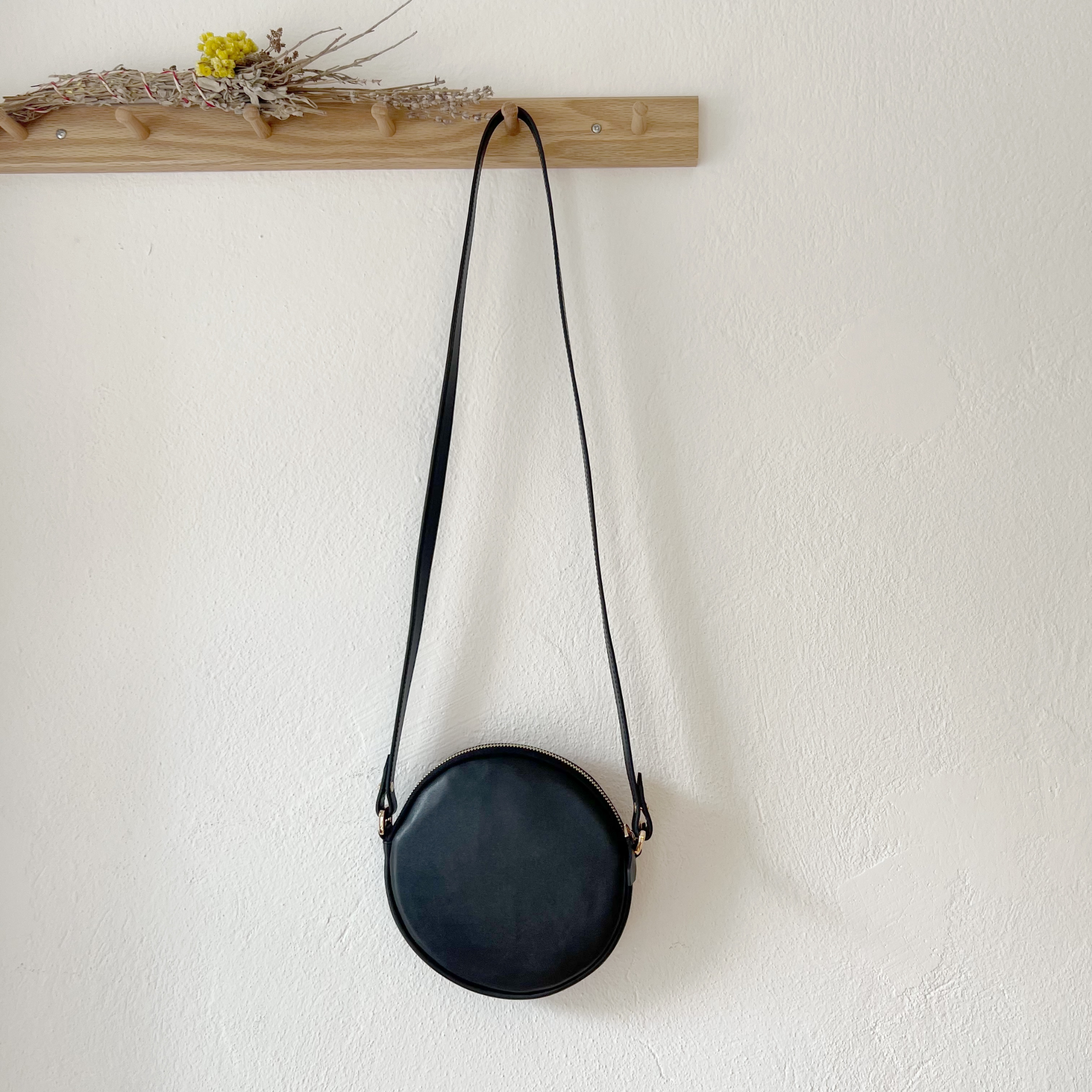 to-go functional leather crossbody bag with interior leather pocket with a K'ai&Vrosi embossed logo