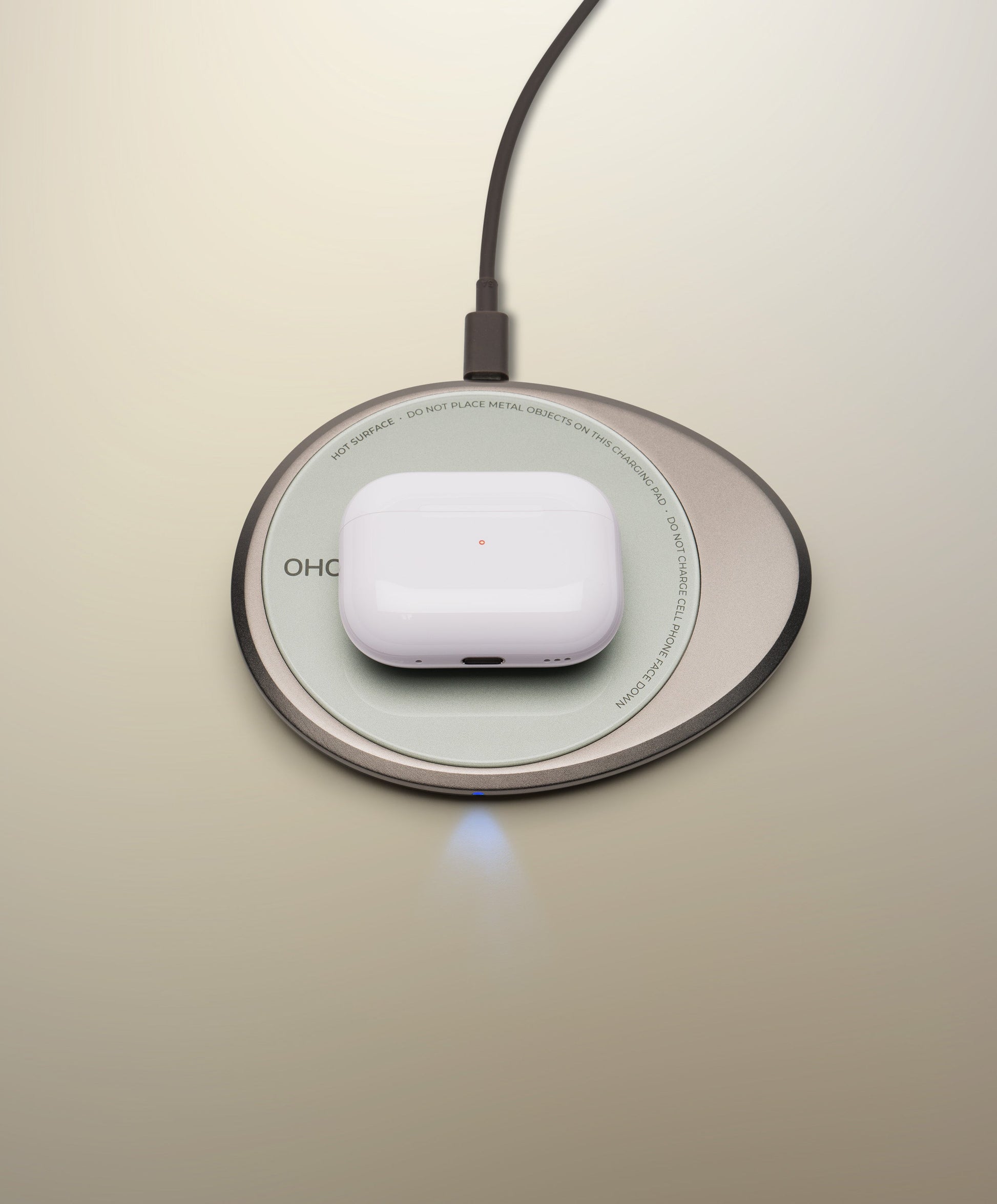 OHOM Pad 3 Cosmic Silver wirelessly charging AirPods