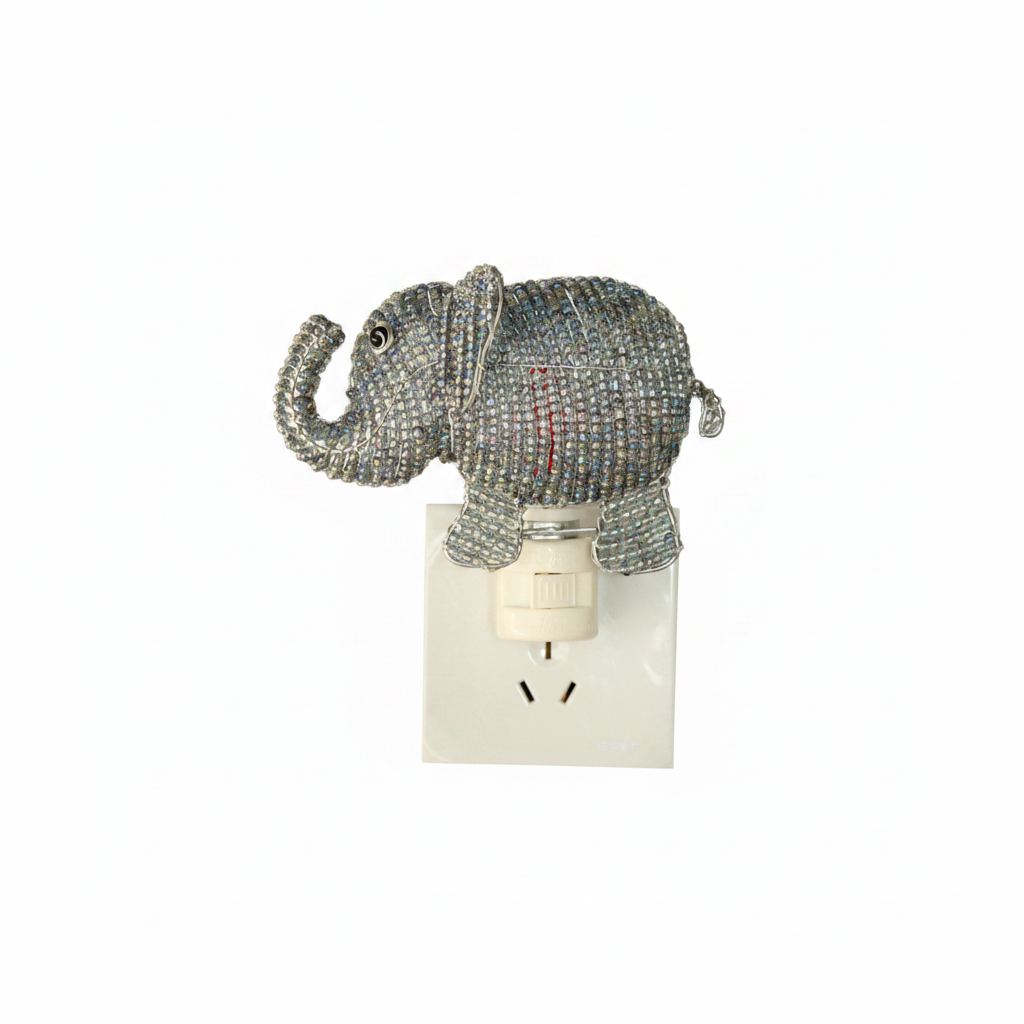 Beaded elephant night light on white background