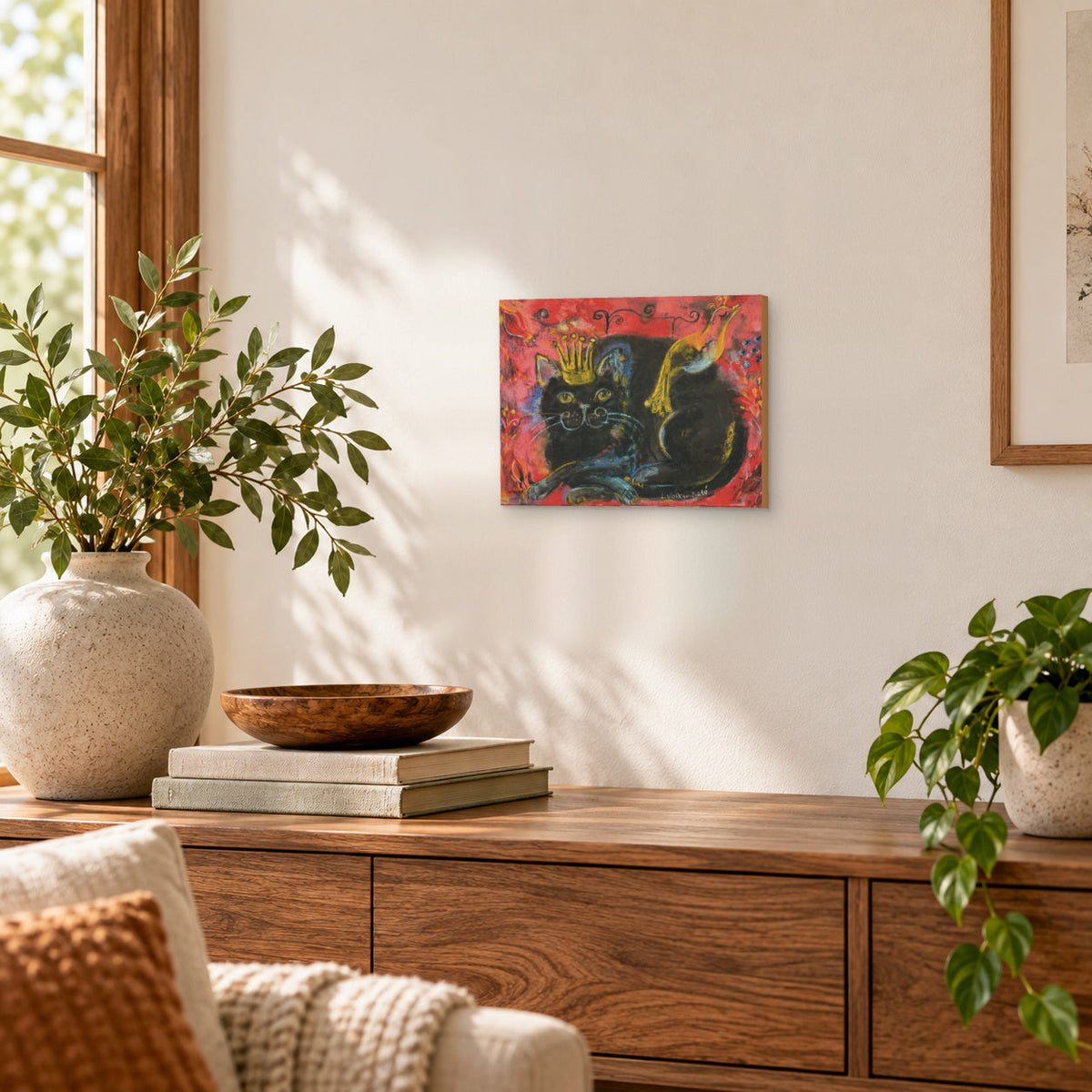 Crowned black cat with bird red folk art print, styled on a wall in a room