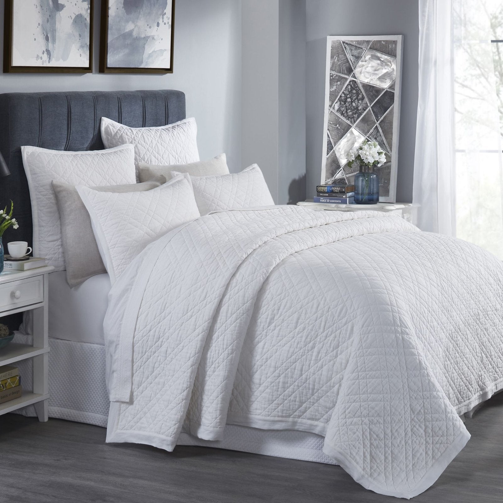 CL-253-11096_2|Crisp white quilted coverlet elegantly adorning a modern bed, offering serene comfort and timeless style for any bedroom.