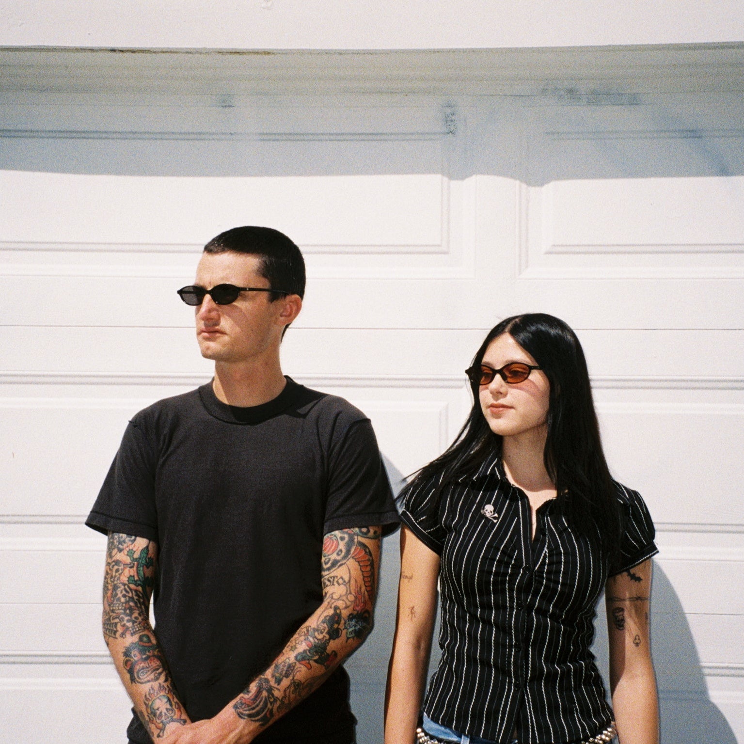 Macey Lemus and Zachary Kovacs wearing SAD Eyewear Celeste oval sunglasses in black with polarized grey UV protection lenses