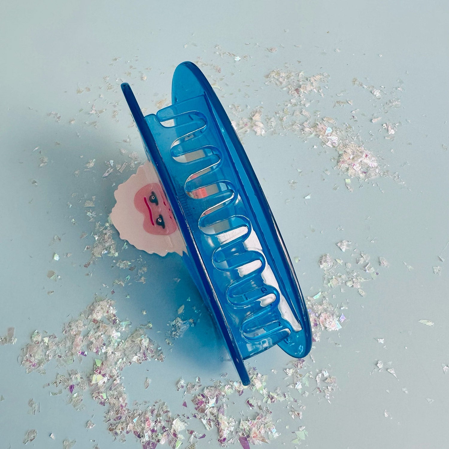 Back of blue snow monkey hair claw on blue background.