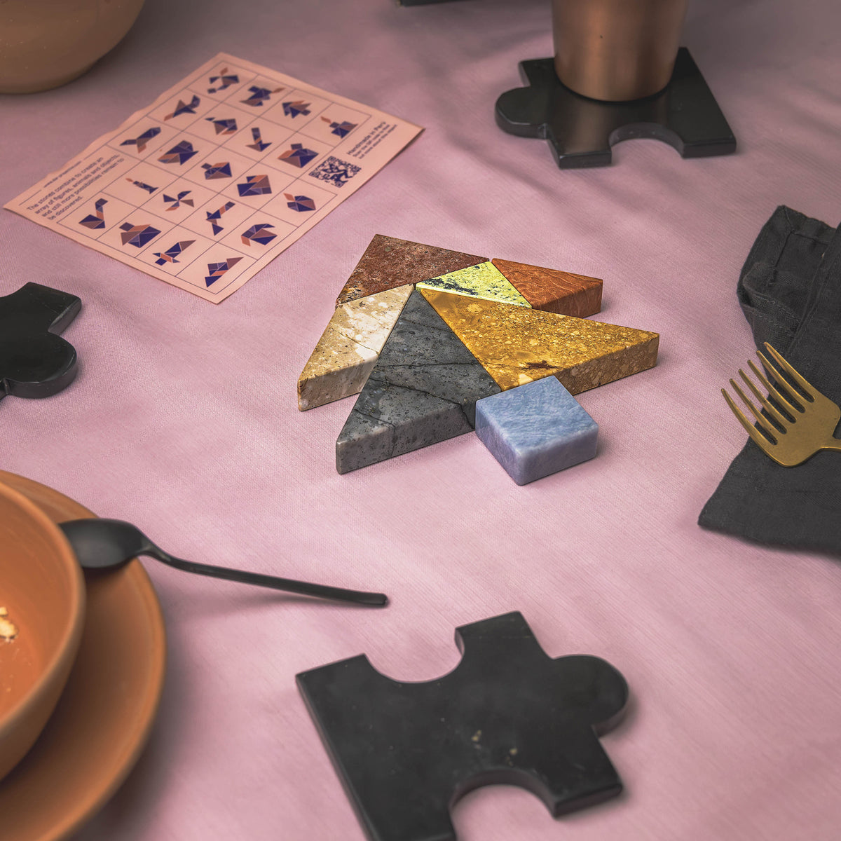 Gemstone Tangram puzzle arranged artistically to highlight its sculptural potential.