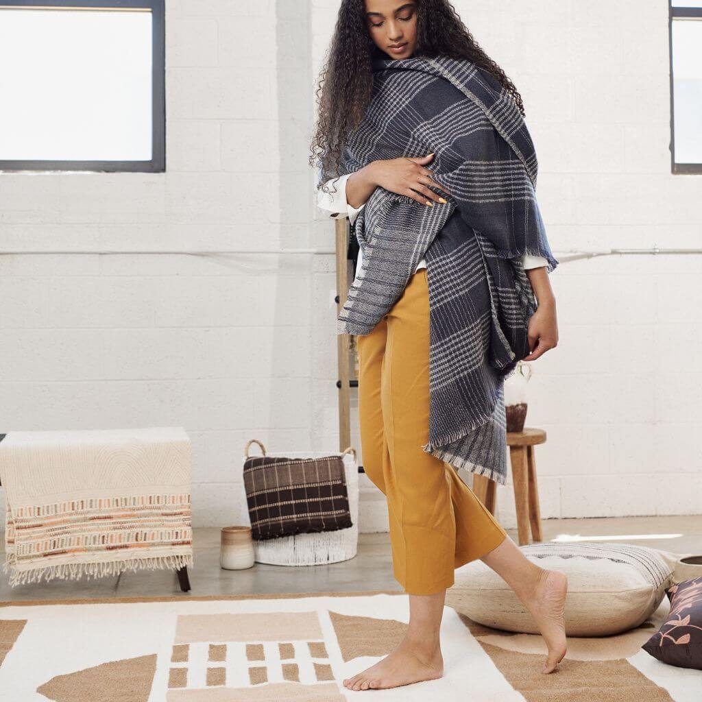 Model showcasing Alloy Dark Blue Stripes Pattern Soft Merino Linen Handloom Throw draped elegantly.