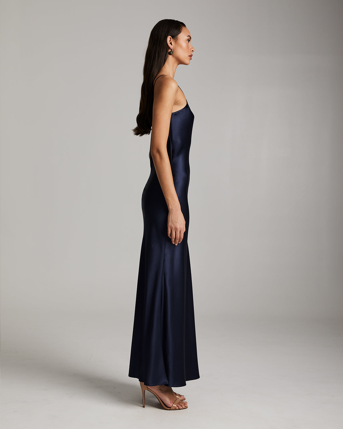 Side view of a model wearing a navy Liquid Silk Slipdress