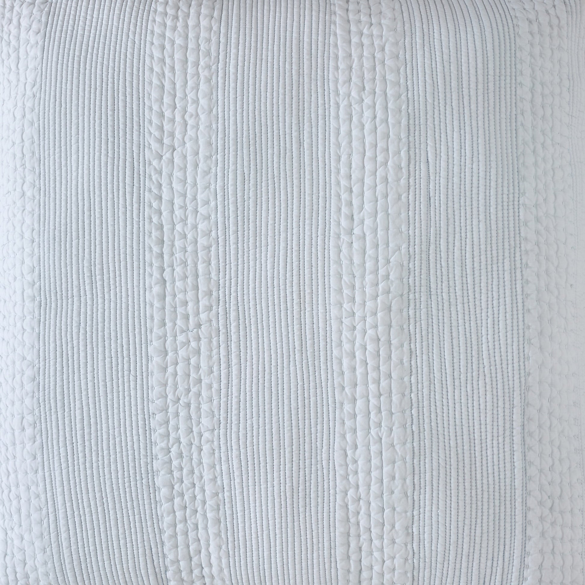 SS-257-2026-LOT1_2|Close-up of light blue quilted coverlet, featuring distinct vertical patterned stripes. Serene bedroom texture.