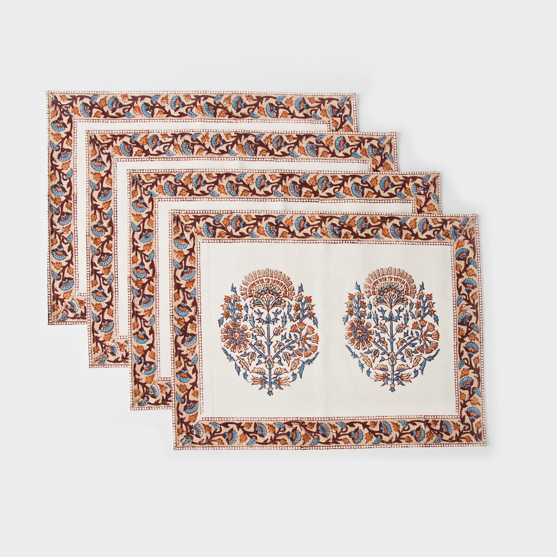 Set of 4 Saffra hand block printed cotton placemats with peachy pink floral motif.