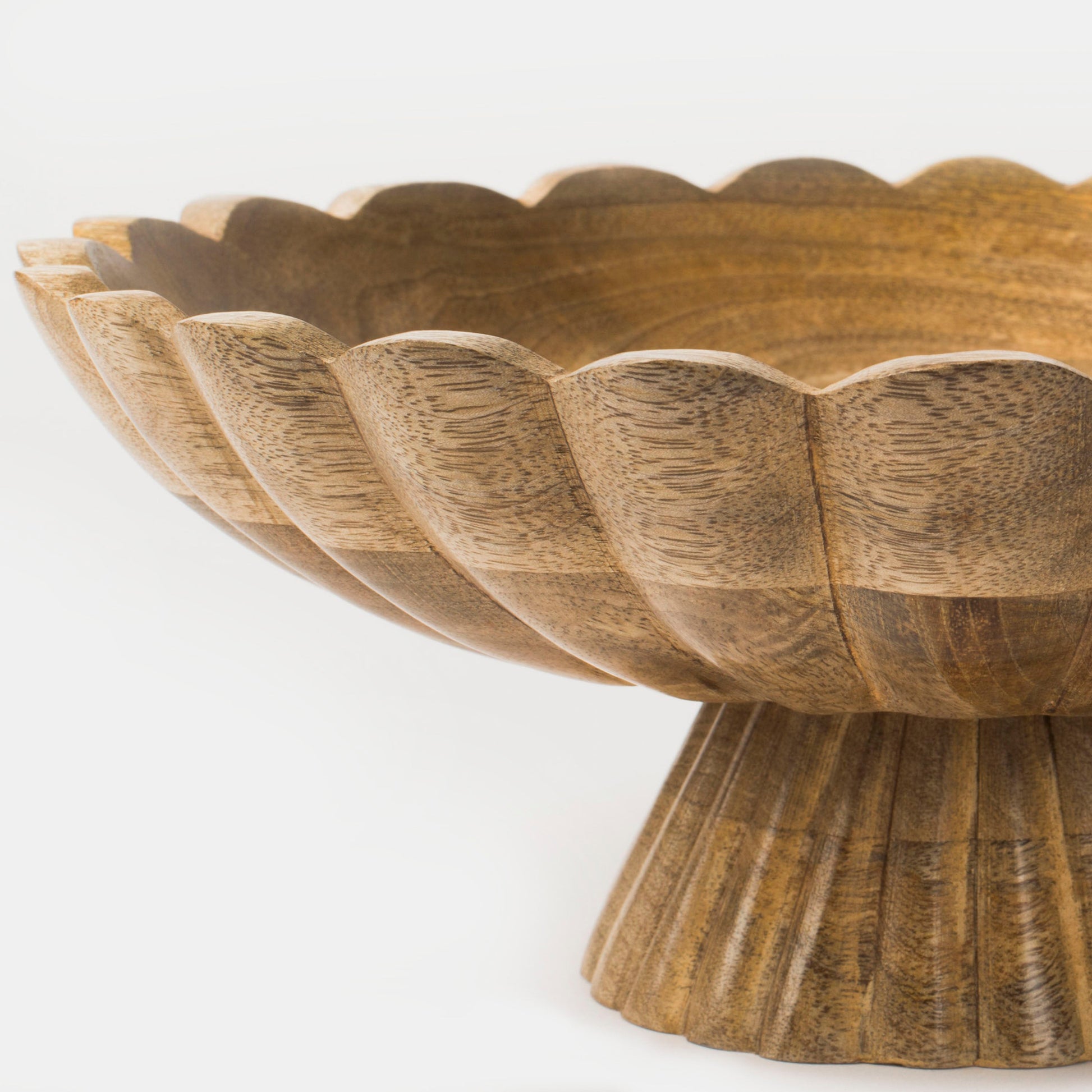Close-up of carved fluted base and natural wood grain