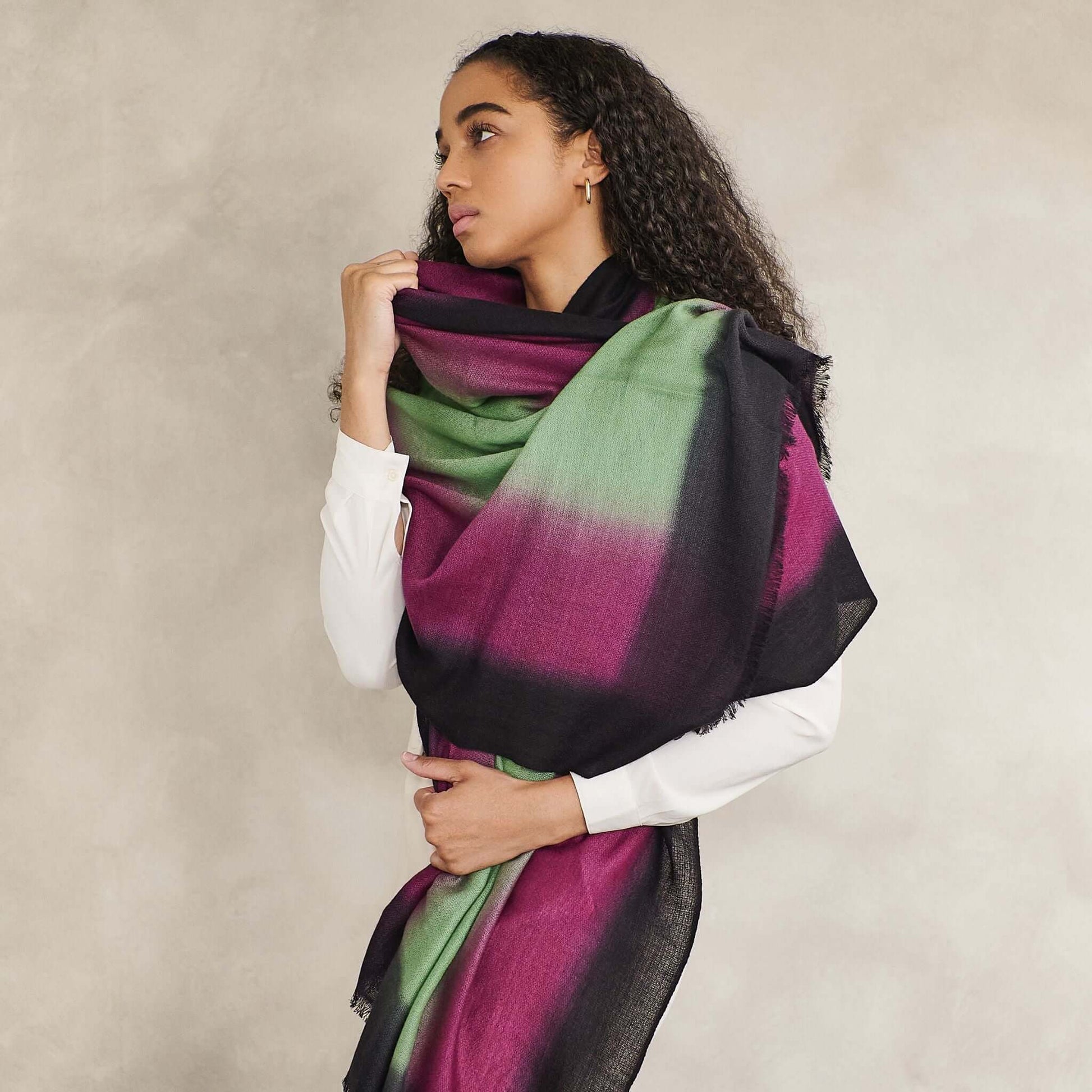 Iris Courtyard Green Purple Hand Woven Cashmere Merino Scarf displayed on a model, showcasing its unique color blend.