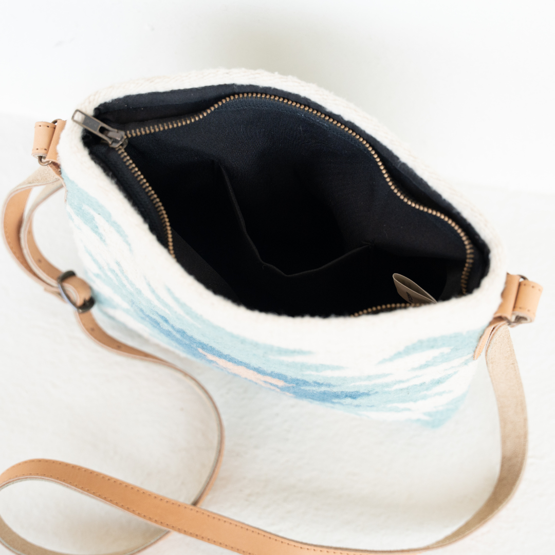 Interior view of Handwoven crossbody bag with abstract Zapotec diamond design in soft spring tones; features adjustable leather strap and two internal pockets for daily essentials