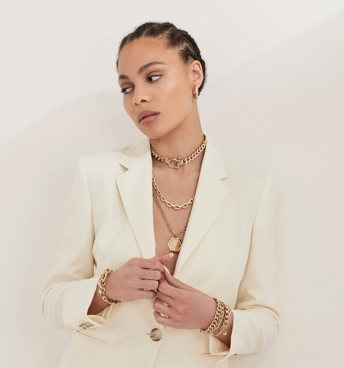 Woman in white blazer wearing Lennon Necklace and gold jewelry stylishly displayed