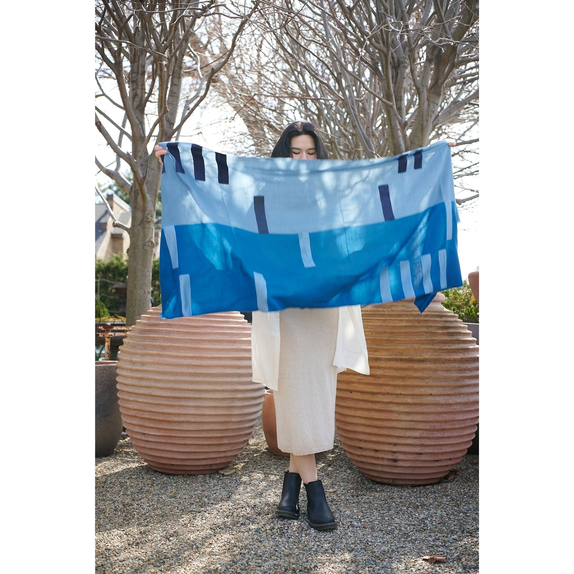 Harbor Blue Silk Merino Hand Woven Hand Embroidered Modern Artisanal Scarf displayed outdoors by a model.