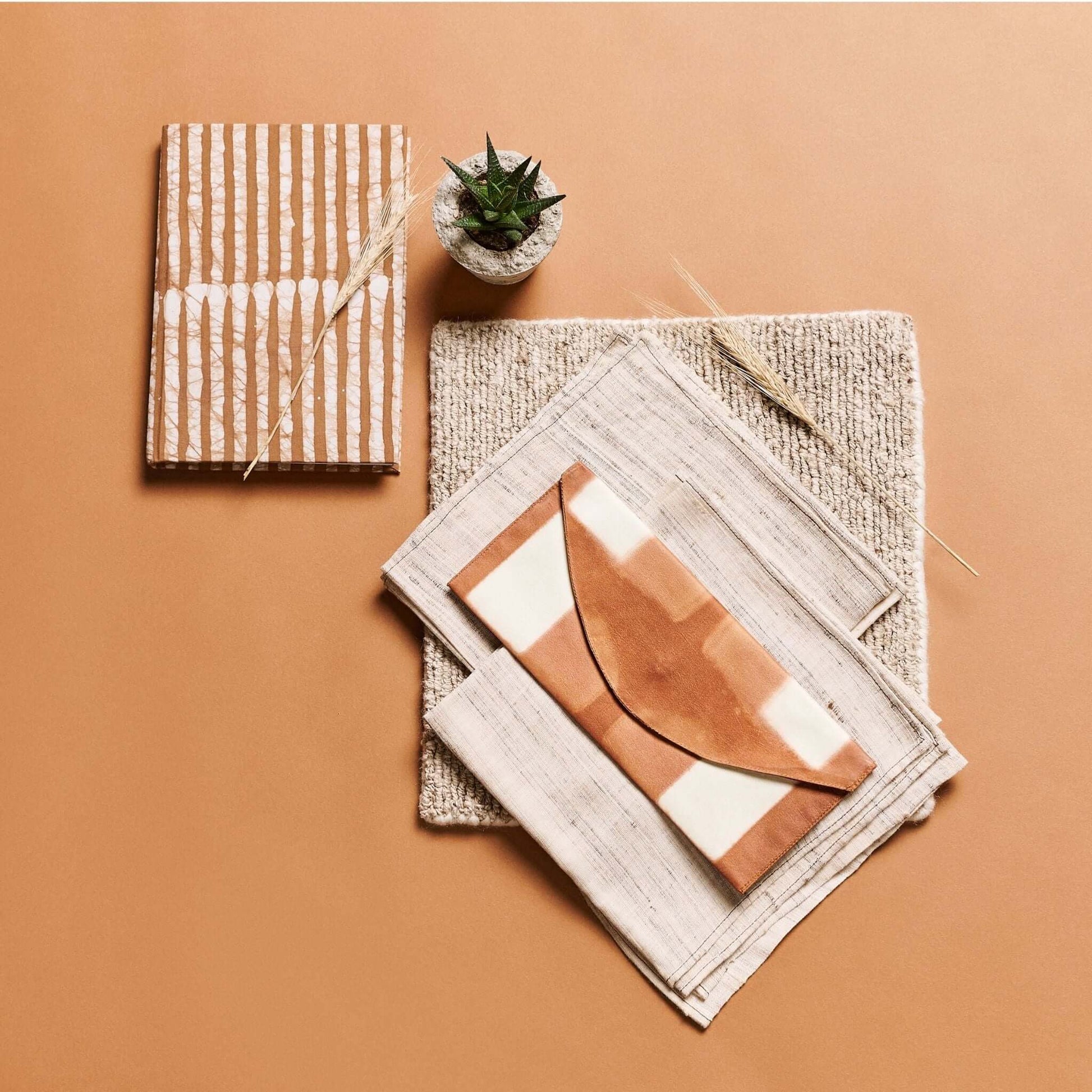 Oak Brown Zero Waste Handmade Artisanal Journal displayed with unique envelopes and a small plant on a textured background.