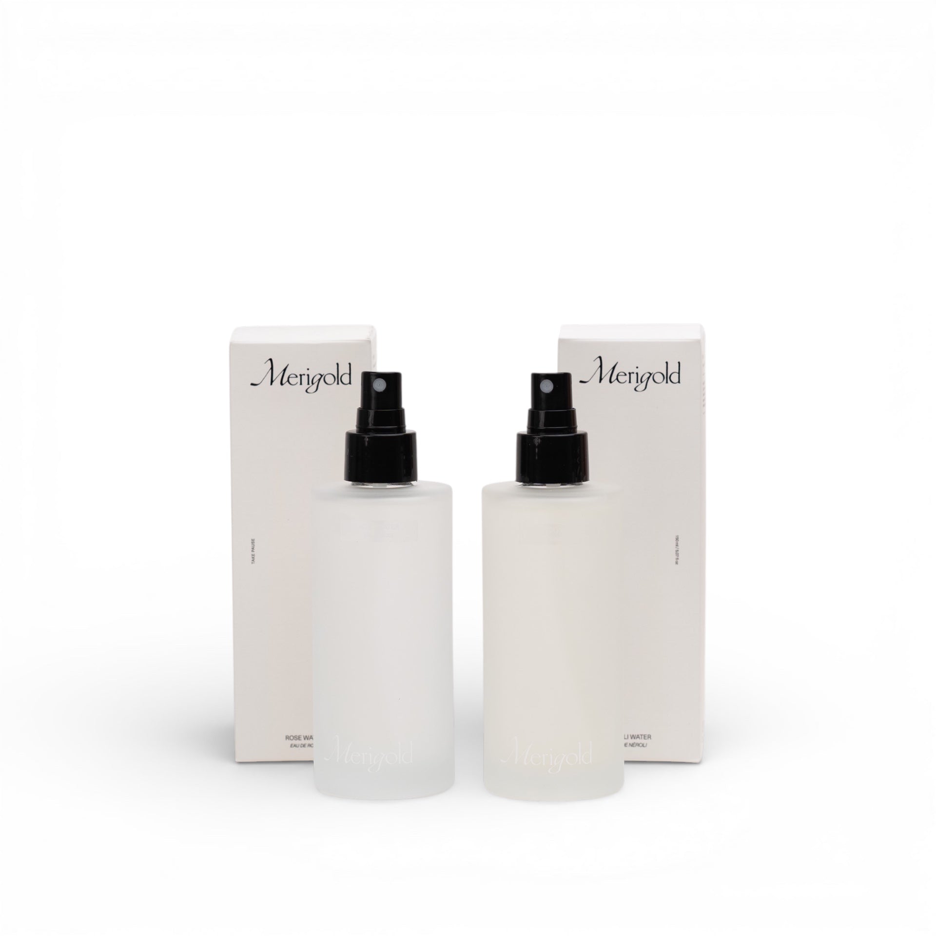 Two skincare bottles with black caps and Merigold branding on a white background