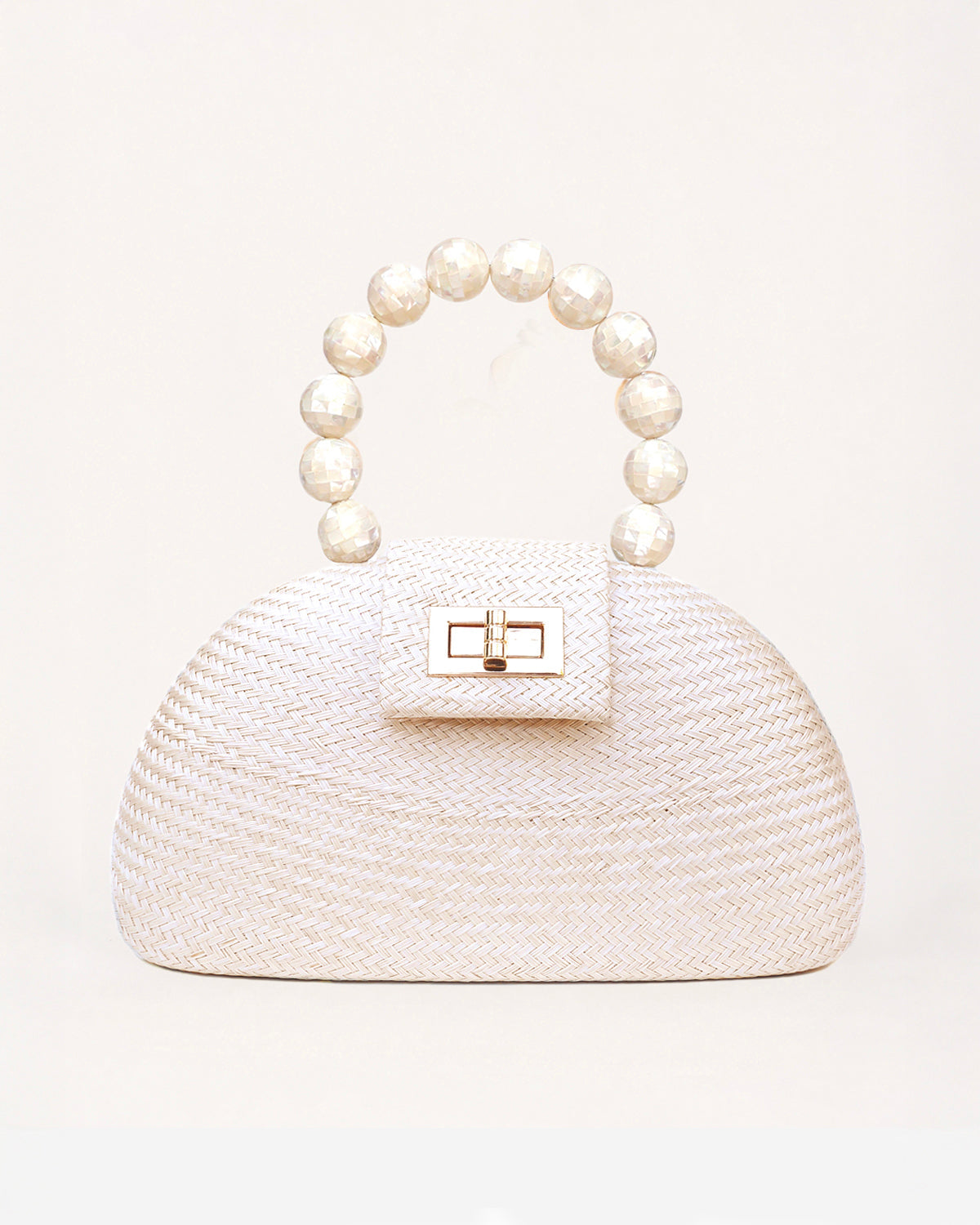 The Orla cream and pearl woven straw half-moon bag with pearl beaded handle, front view