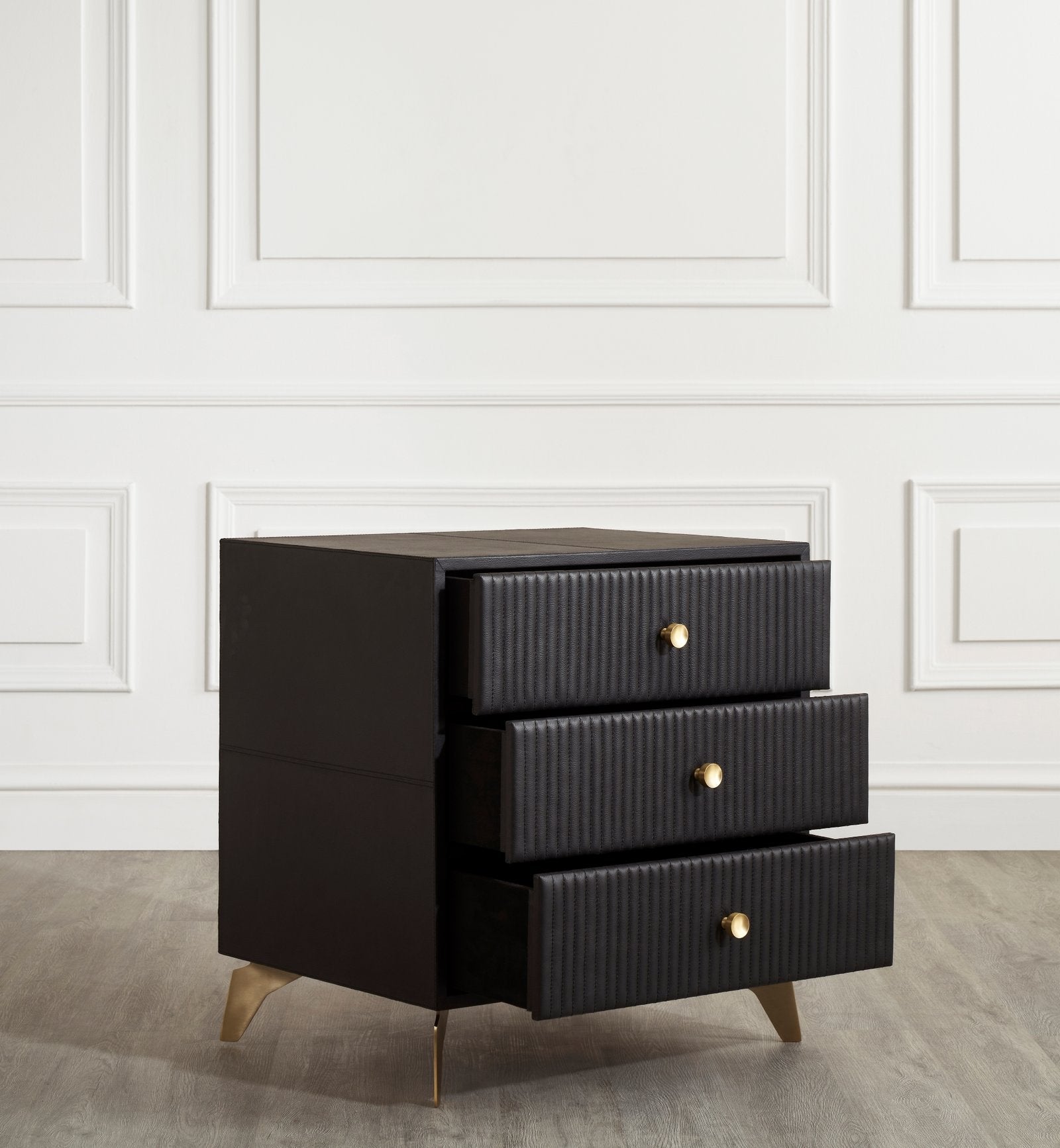 FN-5202-262028_5|Black leather 3-drawer nightstand with top drawer slightly open, showcasing vertical tufting and golden knob. Functional leather furniture.