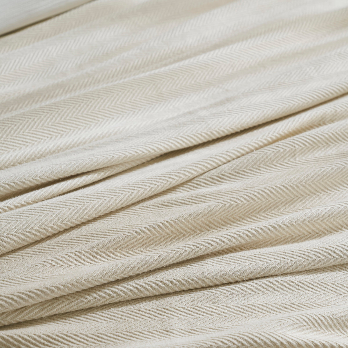 BL-866-9496_5|Detailed close-up of a luxurious light beige herringbone patterned blanket, showcasing its soft, intricate woven texture.