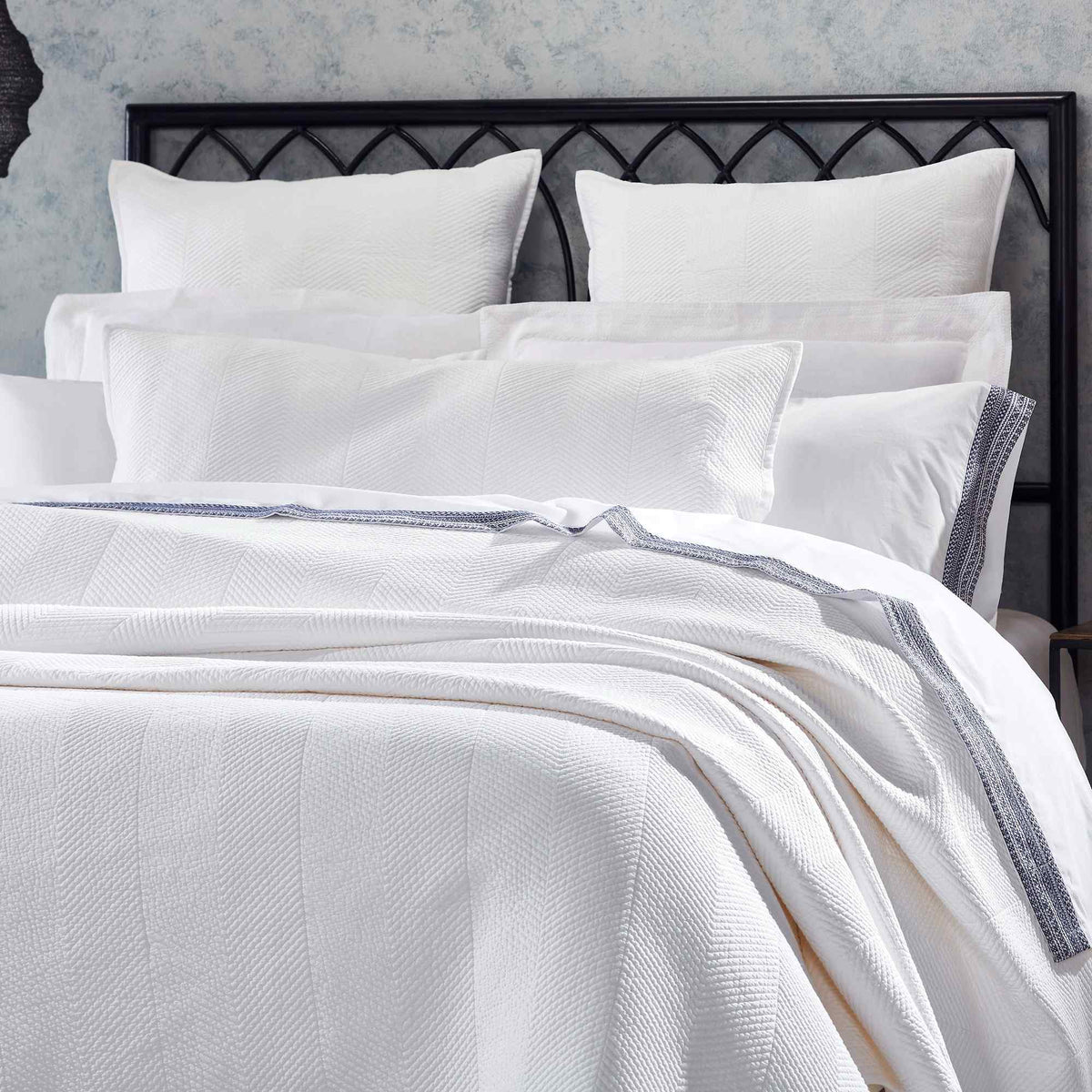 CL-170-9496_4|Close-up of elegant white chevron woven coverlet on a plush bed, showcasing its textured pattern and sophisticated design.