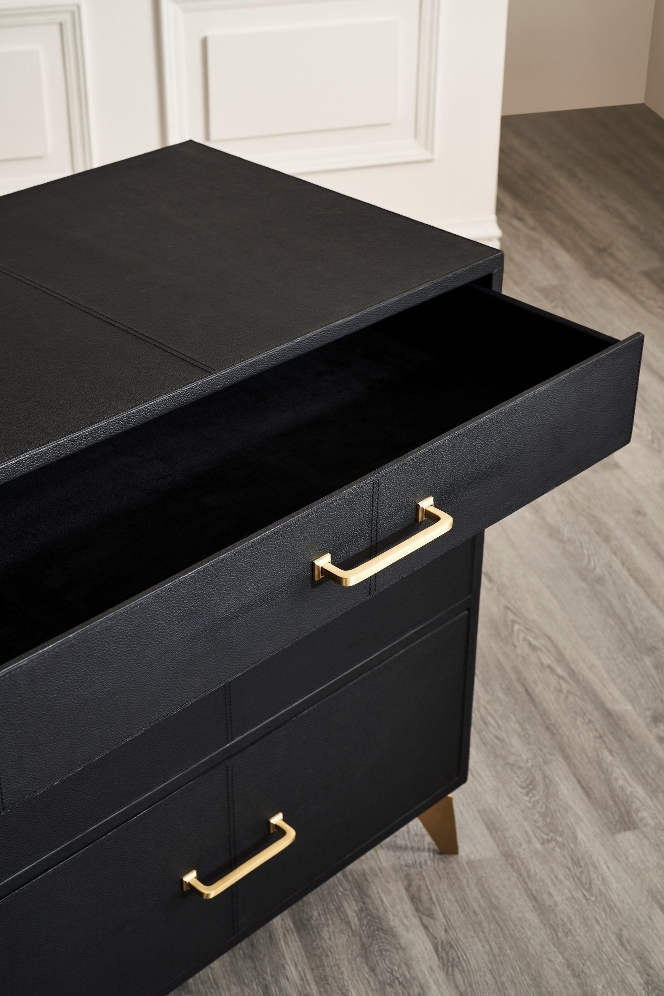 FN-5200-262028_6|Top drawer of a black leather furniture dresser, open to reveal storage space and the luxurious texture of its finish.