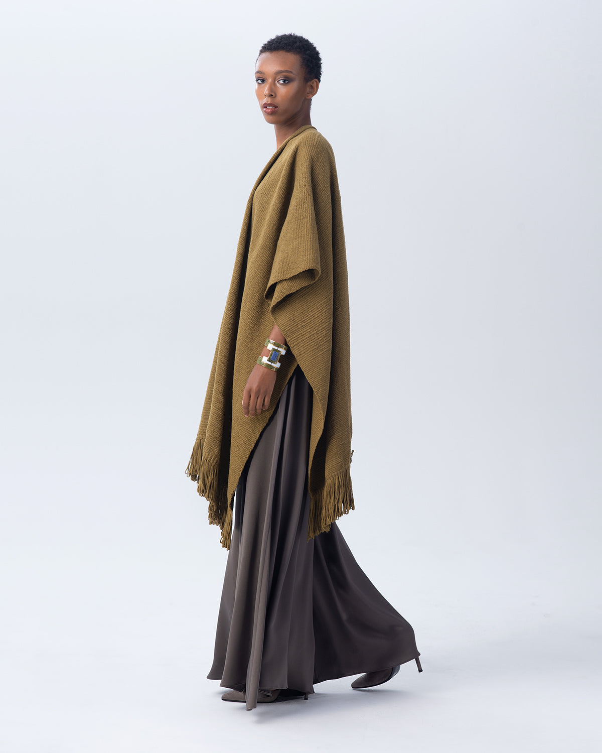 Model wearing an olive Cotton Duna Fringe Duster poncho with fringes