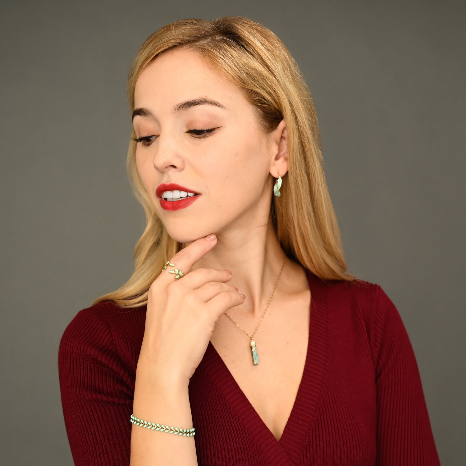 Woman wearing matching mint green and gold jewelry, gold jewelry sets, jewelry pairings, jewelry stores like pandora 