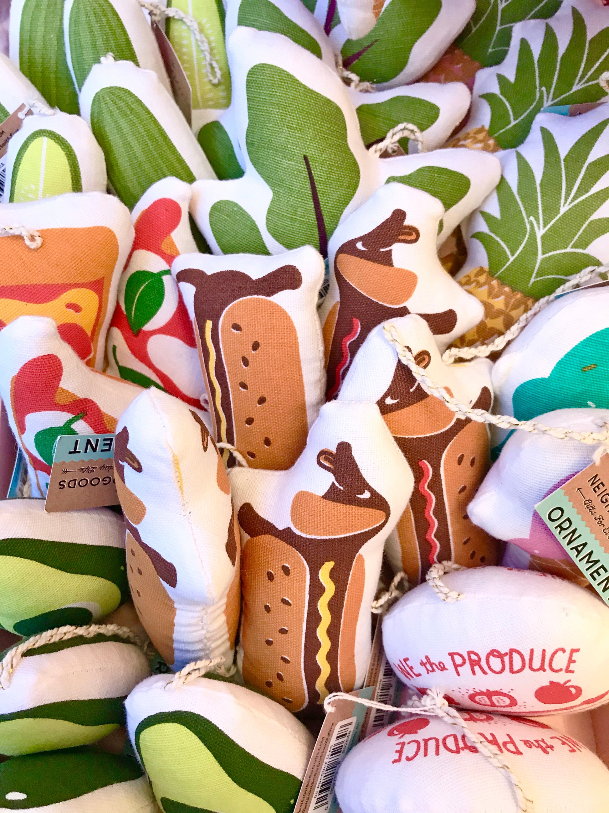 Hot dog ornaments surrounded by an array of other Neighborgoods ornaments