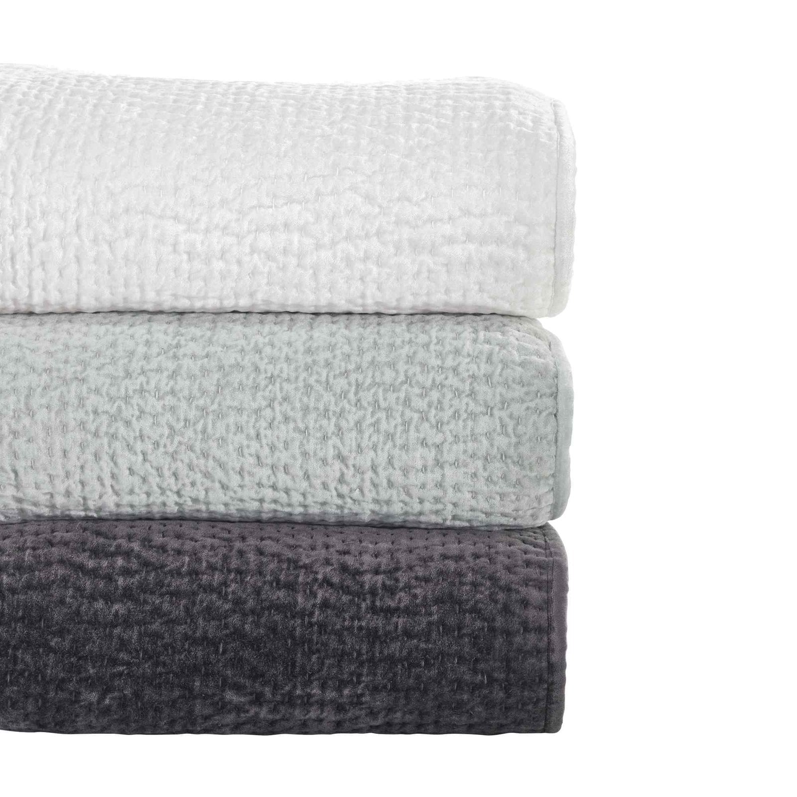 CL-182-9496-LOT1_6|Stack of three textured coverlets in white, sage green, and charcoal grey, showcasing versatile bedroom options.